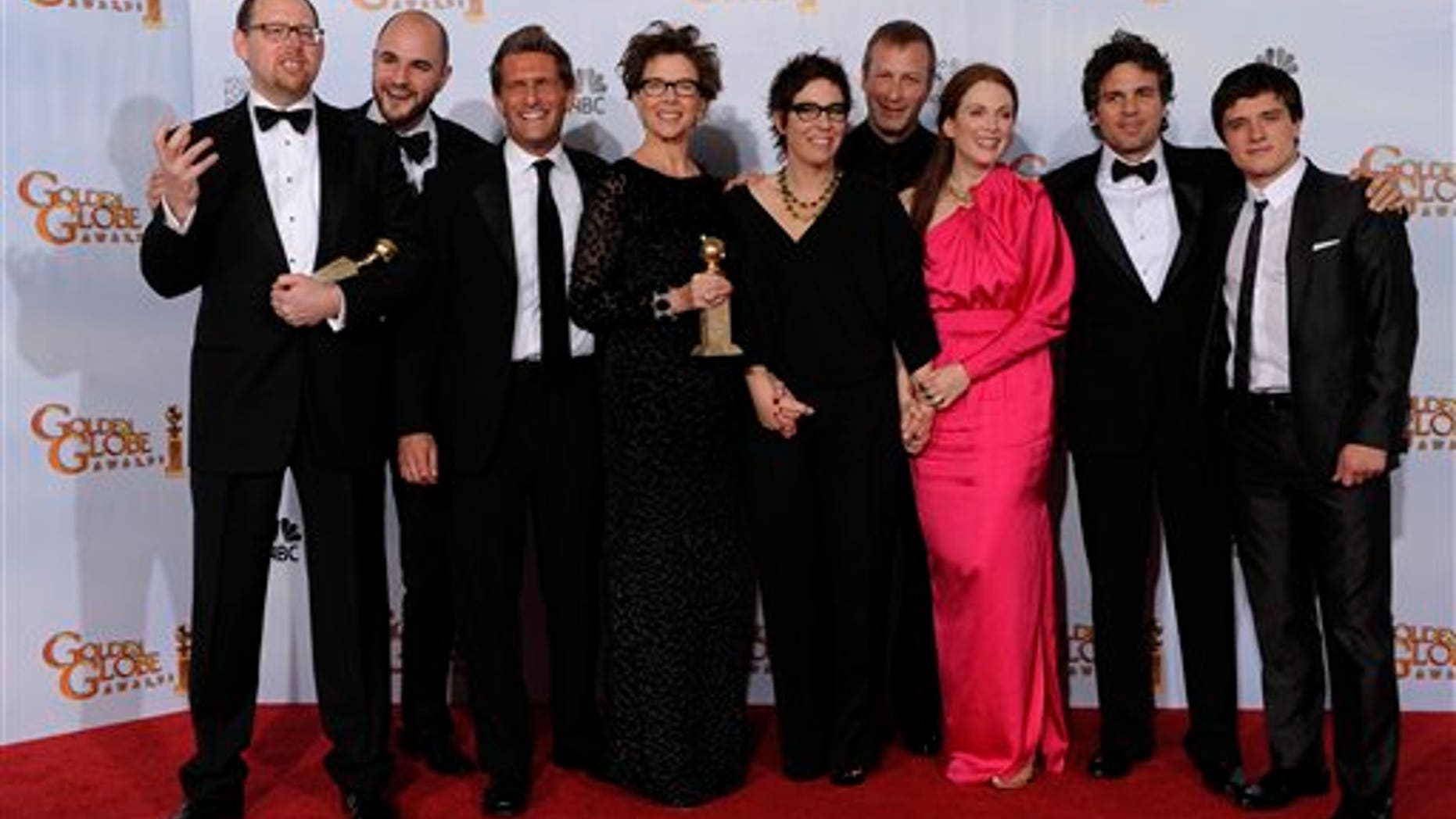 The cast and crew of "The Kids Are All Right," pose with the award they won for Best Motion Picture - Comedy Or Musical at the Golden Globe Awards Sunday, Jan. 16, 2011, in Beverly Hills, Calif. (AP Photo/Matt J. Terrill)