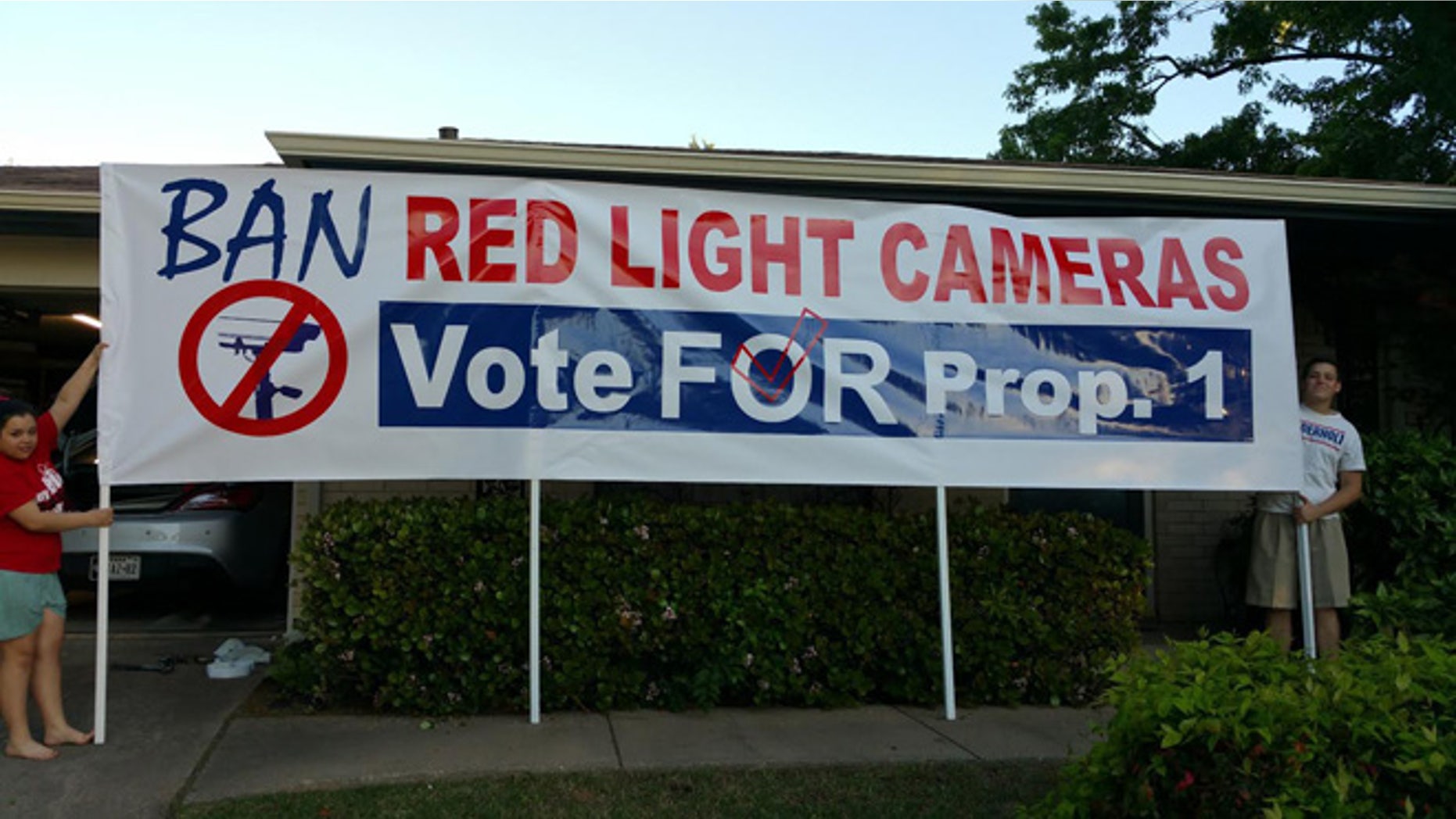 Anti-traffic camera protesters are seen demonstrating in Arlington.