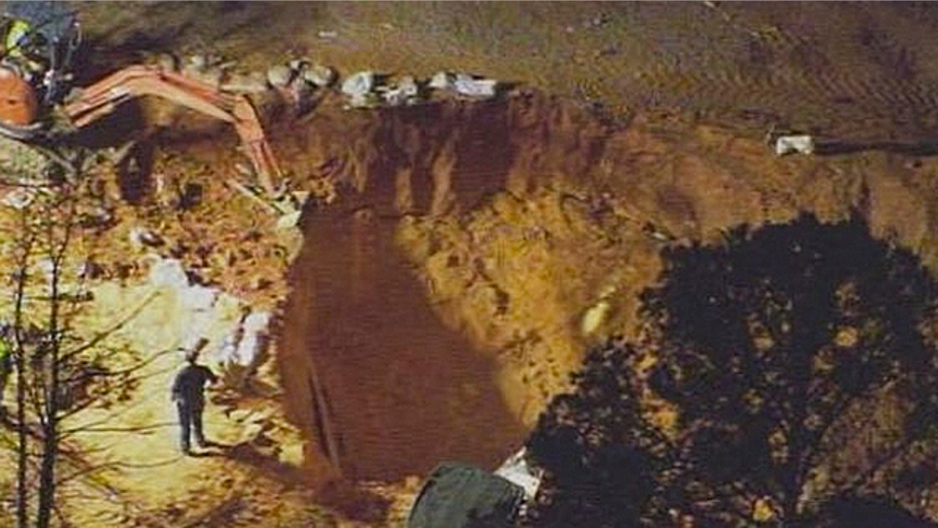 April 7, 2013: In this image made from video and provided by WSOC-TV Charlotte, authorities work to rescue two children at a construction site.