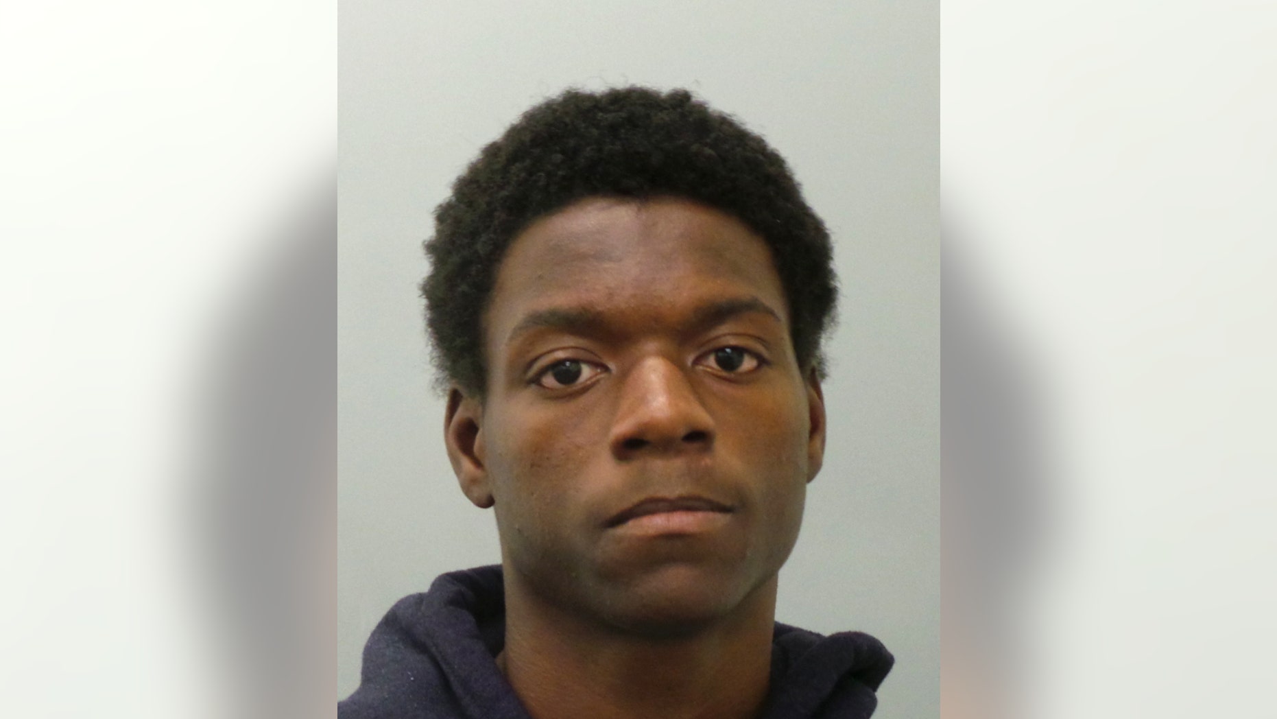 In this undated photo provided by the St. Louis County Police Department, Joshua Williams poses for a booking photo, in St. Louis, Mo. Williams, a protester who advocated for peaceful demonstrations in Ferguson was charged Saturday, Dec. 27, 2014, with setting fire to a convenience store in a neighboring suburb. A St. Louis County jail official said Williams, 19, of St. Louis, was being held on $30,000 bond. He is charged with arson, second-degree burglary and stealing less than $500. (AP Photo/St. Louis County Police Department)