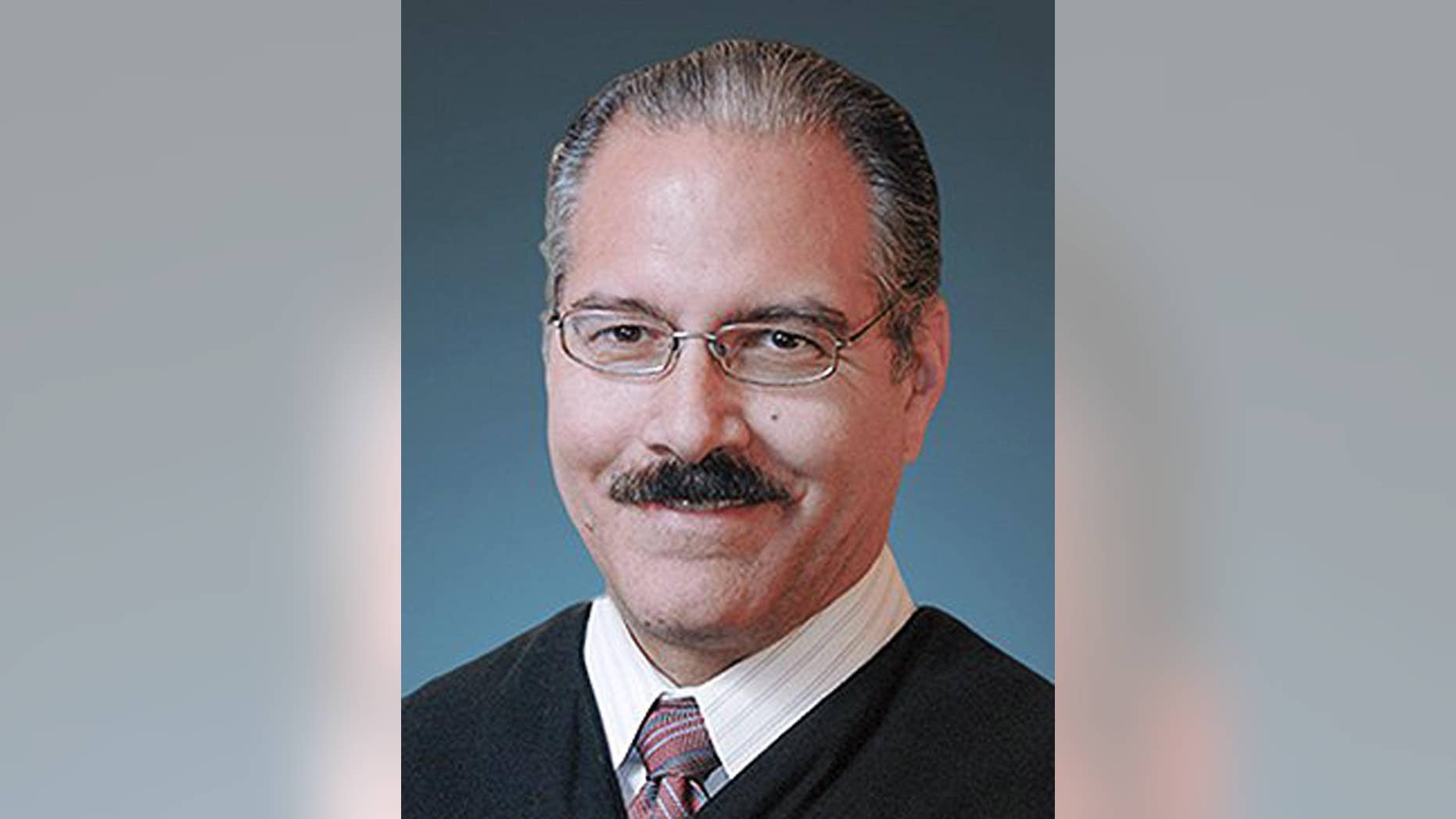 This photo provided by the Tulsa County District Court shows District Judge James Caputo. Caputo, who is assigned to the case of a volunteer deputy accused of manslaughter in the shooting of a restrained suspect, said in a court filing Wednesday, April 22, 2015 that he is considering whether to recuse himself due to his close ties to the Tulsa, Oklahoma, sheriff's office. (Tulsa County District Court via AP)