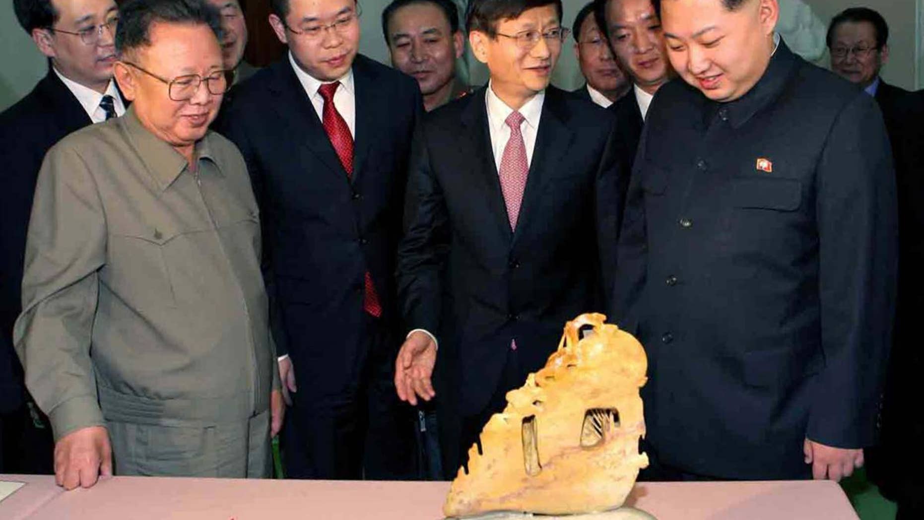 This photo released by Korean Central News Agency via Korea News Service in Tokyo Tuesday, Feb. 15, 2011, shows North Korean leader Kim Jong Il, front left, and his son Kim Jong Un, front right, looking at the gifts brought by visiting Chinese Minister of Public Security Meng Jianzhu, center, in Pyongyang, North Korea, on Monday, Feb. 14, 2011. (AP Photo/Korean Central News Agency via Korea News Service)