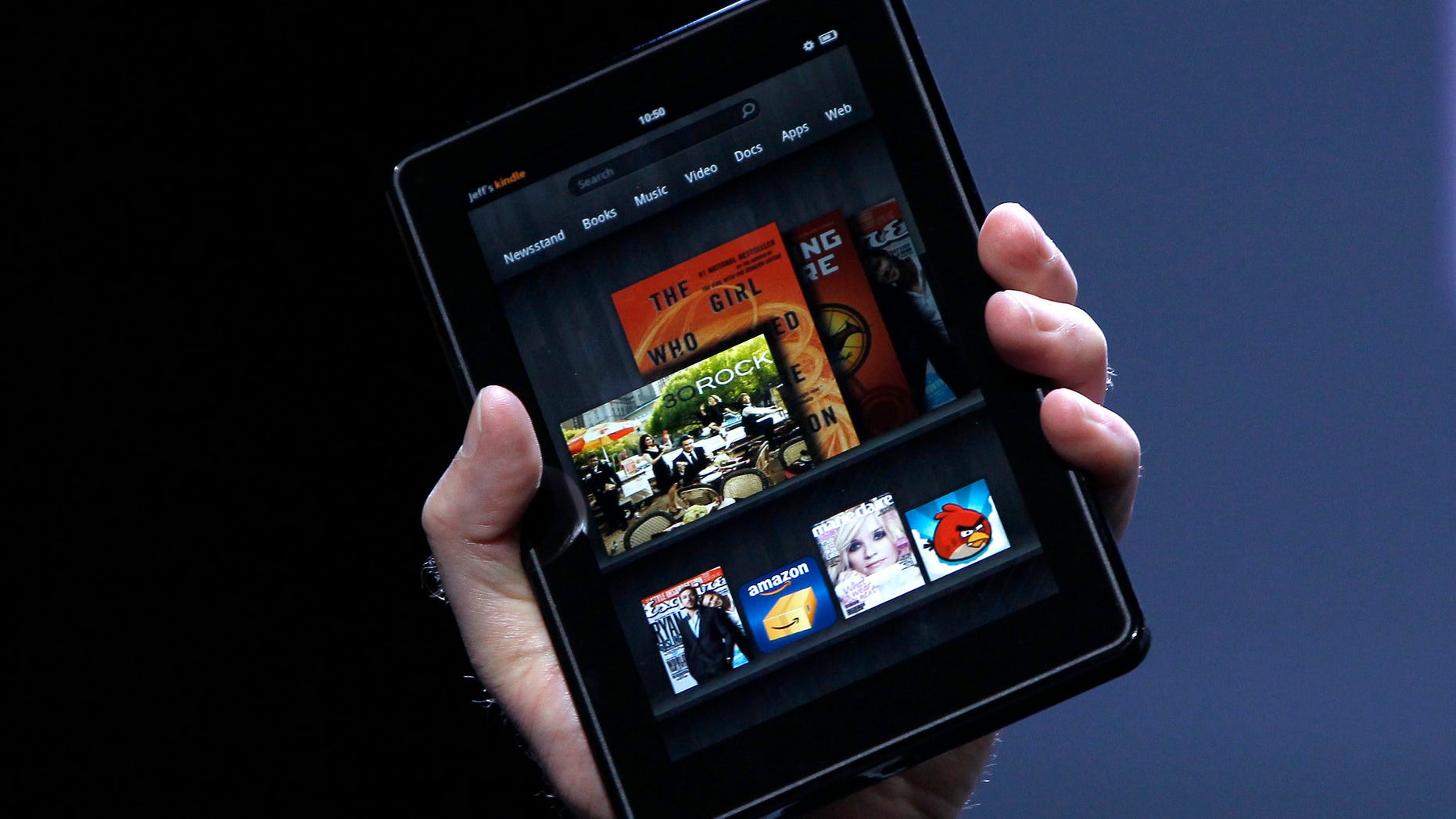 Amazon CEO Jeff Bezos holds up the new Kindle Fire at a news conference during the launch of Amazon's new tablets in New York, September 28, 2011. REUTERS/Shannon Stapleton (UNITED STATES - Tags: BUSINESS SCIENCE TECHNOLOGY) - RTR2RYAH