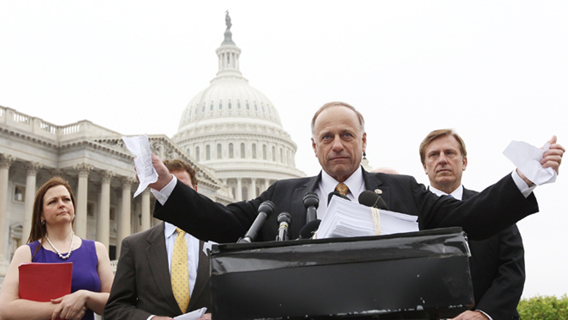 WASHINGTON, DC - MARCH 21: U.S. Rep. Steve King (R-IA) tears a page from the national health care bill during a press conference at the U.S. Capitol March 21, 2012 in Washington, DC. Republican members from the House of Representatives gatherered to speak out against the health care bill which is the topic of a case before the Supreme Court next week. (Photo by Win McNamee/Getty Images)