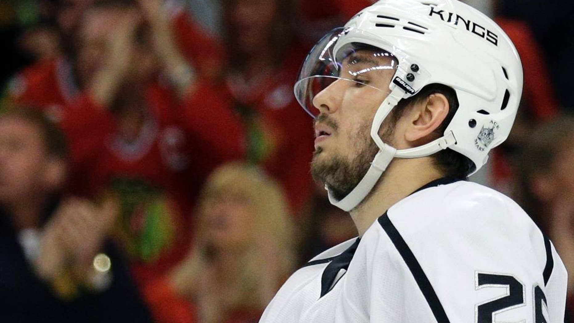 FILE - In this May 18, 2014, file photo, Los Angeles Kings' Slava Voynov reacts during the second period in Game 1 of the Western Conference finals in the NHL hockey Stanley Cup playoffs in Chicago. Voynov has been charged with felony domestic violence. The Los Angeles County district attorney’s office announced the charge Thursday, Nov. 20, 2014. Voynov faces one felony count of corporal injury to a spouse with great bodily injury. The district attorney’s office says Voynov “caused his wife to suffer injuries to her eyebrow, cheek and neck” during an argument. (AP Photo/Nam Y. Huh, File)