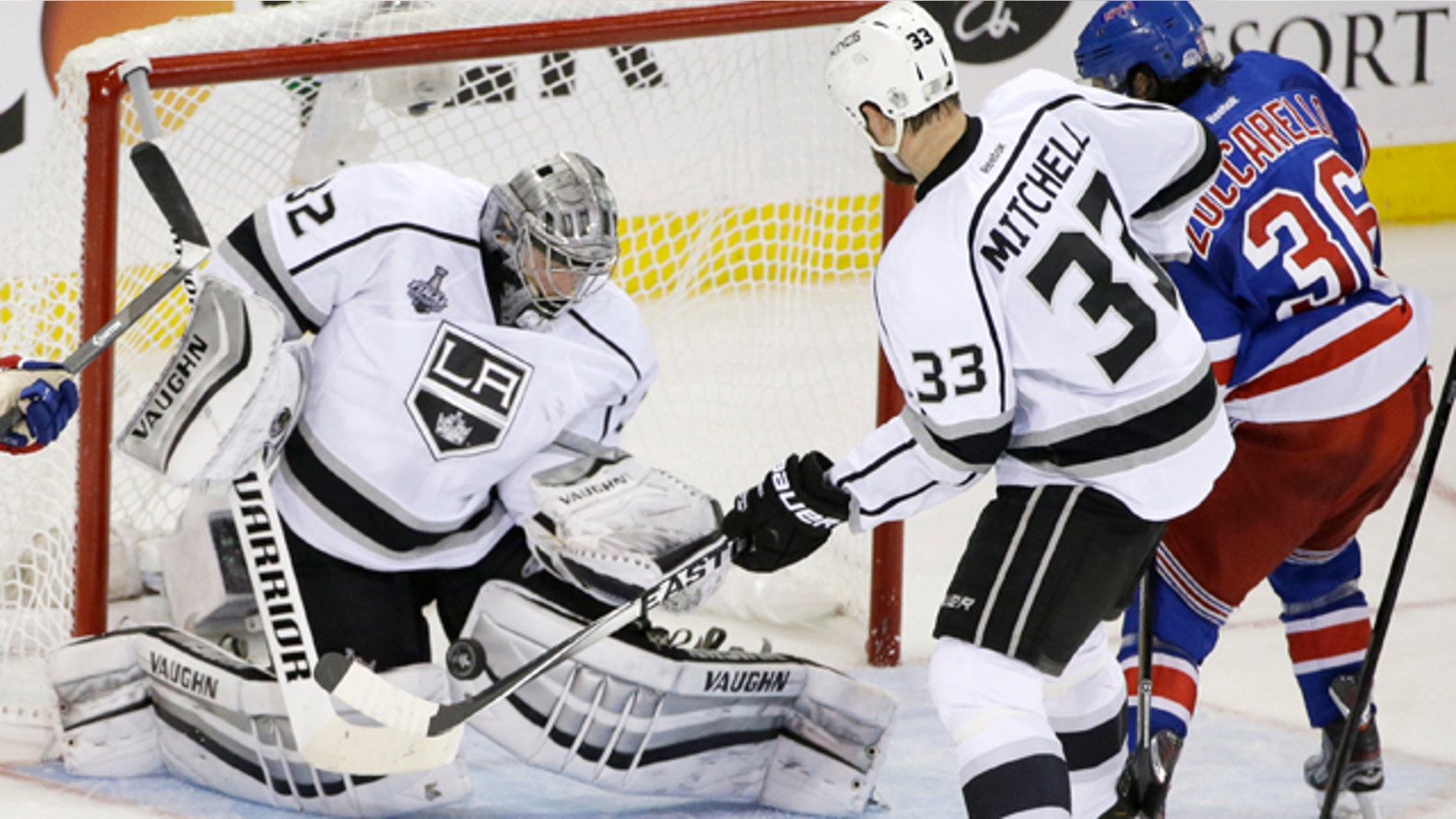 June 9, 2014: Los Angeles Kings goalie Jonathan Quick (32) blocks a shot by New York Rangers right wing Mats Zuccarello (36) as Kings defenseman Willie Mitchell (33) helps defend in the second period during Game 3 of the Stanley Cup Final. (AP Photo/Frank Franklin II)