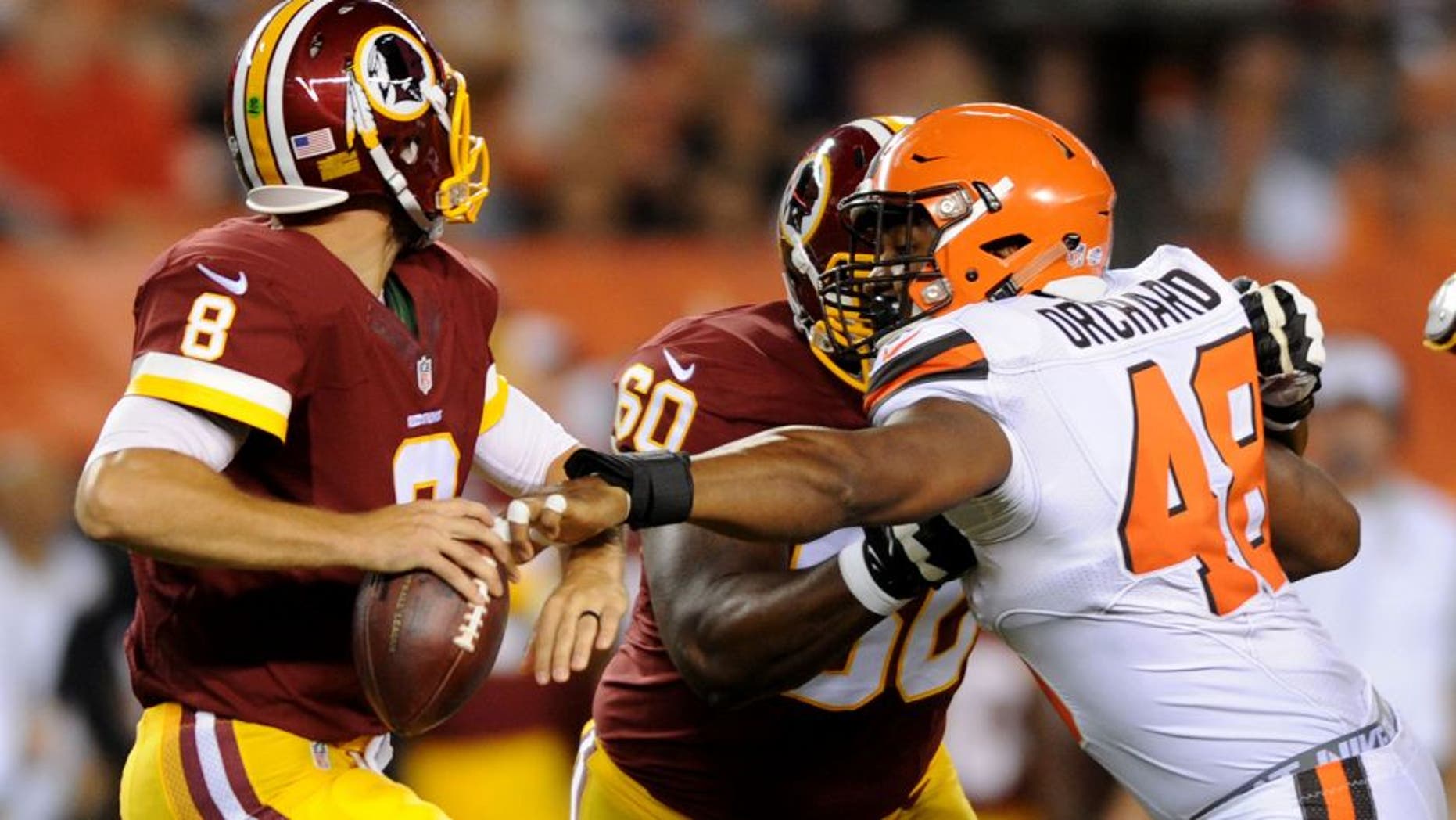 Aug 13, 2015; Cleveland, OH, USA; Cleveland Browns linebacker Nate Orchard (48) gets a hand on Washington Redskins quarterback Kirk Cousins (8) as Washington Redskins tackle Willie Smith (60) blocks during the second quarter in a preseason NFL football game at FirstEnergy Stadium. Mandatory Credit: Ken Blaze-USA TODAY Sports