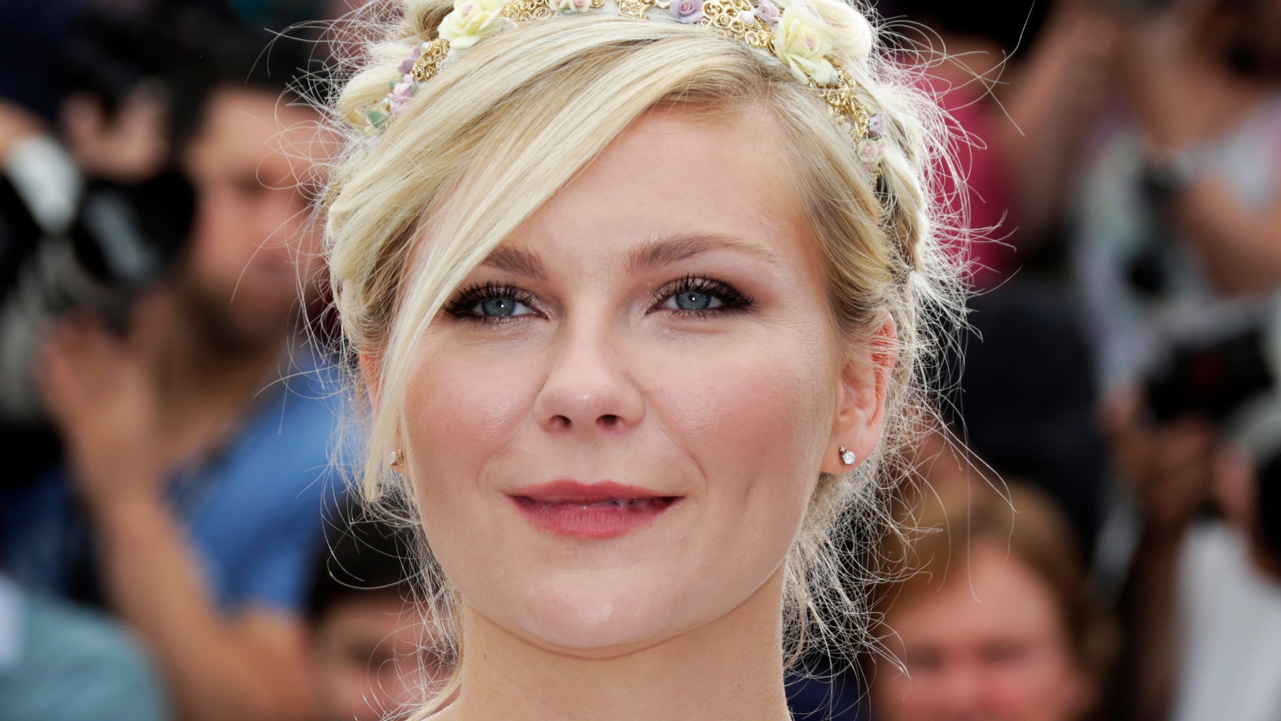 Cast member Kirsten Dunst poses during a photocall for the film "On The Road", in competition at the 65th Cannes Film Festival, May 23, 2012.
