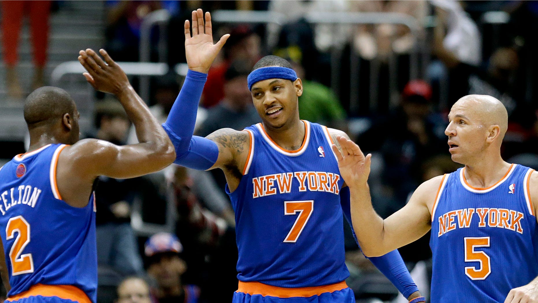 New York Knicks' Carmelo Anthony, center, high-fives teammates Raymond Felton, left, and Jason Kidd after the Knicks beat the Atlanta Hawks 95-82 in an NBA basketball game, Wednesday, April 3, 2013, in Atlanta. (AP Photo/David Goldman)