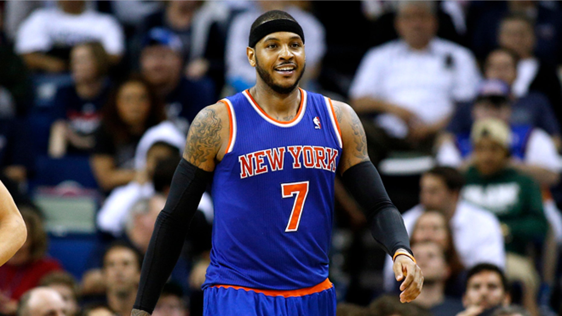 New York Knicks small forward Carmelo Anthony (7) smiles after scoring during the second half of an NBA basketball game against the New Orleans Pelicans in New Orleans, Wednesday, Feb. 19, 2014. The Knicks won 98-91. (AP Photo/Jonathan Bachman)