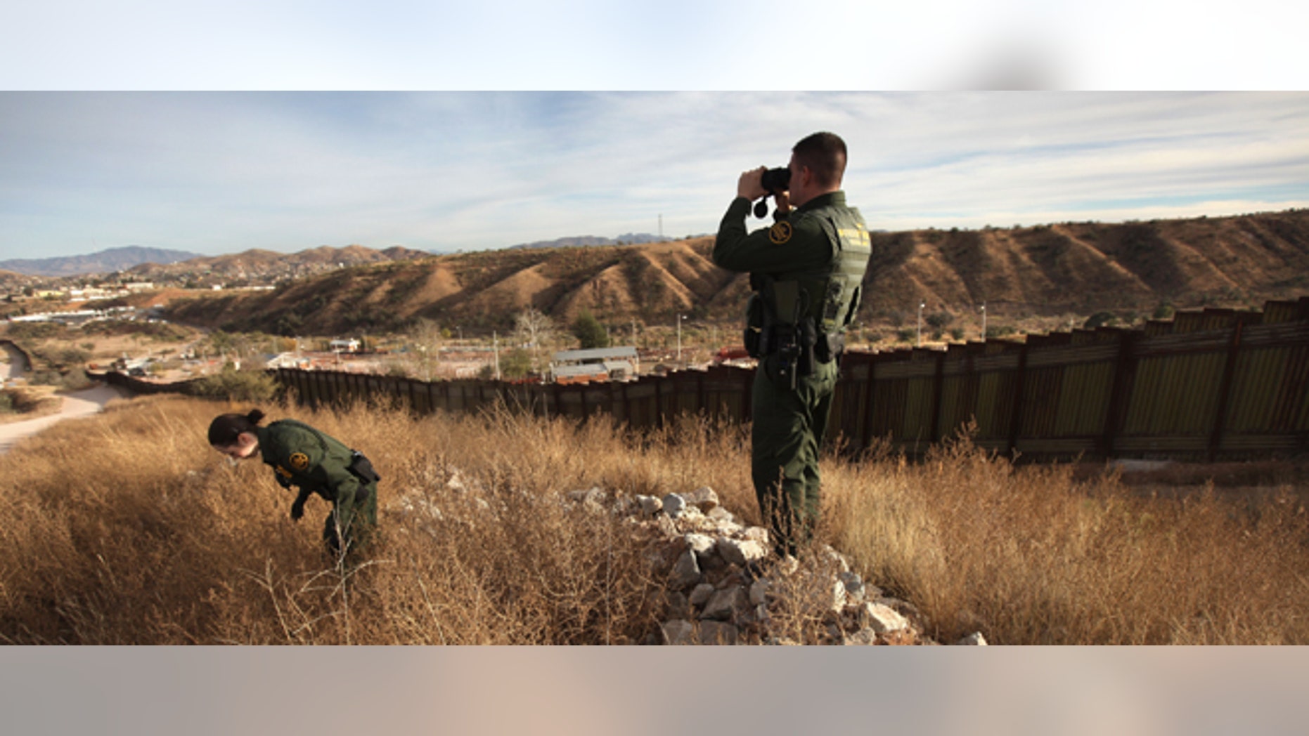 NOGALES, AZ - DECEMBER 07: U.S. Border Patrol agents Richard Funke and Colleen Agle look for illegal immigrants crossing the U.S.- Mexico border on December 7, 2010 near Nogales, Arizona. Although a new fence has been built along the majority of Arizona's border with Mexico, critics have called for fencing of the entire stretch. Much of the unfenced terrain is in remote and mountainous areas. Although illegal immigration has slowed all along the U.S. Mexico border, Border Patrol officials say the Tucson sector remains the most heavily trafficked in the nation. (Photo by John Moore/Getty Images)