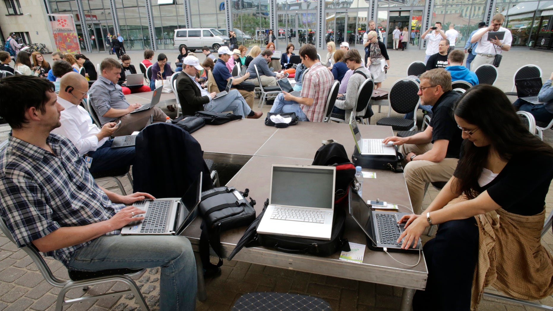 People use their laptops during "Working everywhere" event in Riga May 31, 2013. More than 150 activists with laptops and wi-fi access attended event to demonstrate the benefits of flexible working style and possibly set a new Guinness world record for "Most people who work in a specific place outside the office". REUTERS/Ints Kalnins (LATVIA - Tags: SOCIETY) - RTX107GW