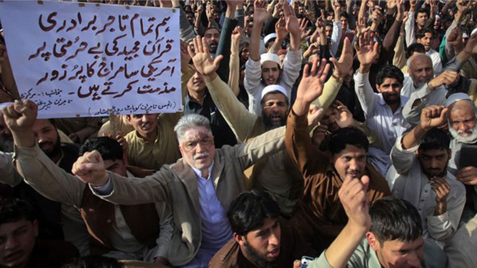 March 6, 2012: Traders hold placards as they shout anti-U.S. slogans during a demonstration in Peshawar. About 200 protesters gathered to condemn the February 21 burning of copies of the Koran at NATO's main base in Afghanistan.