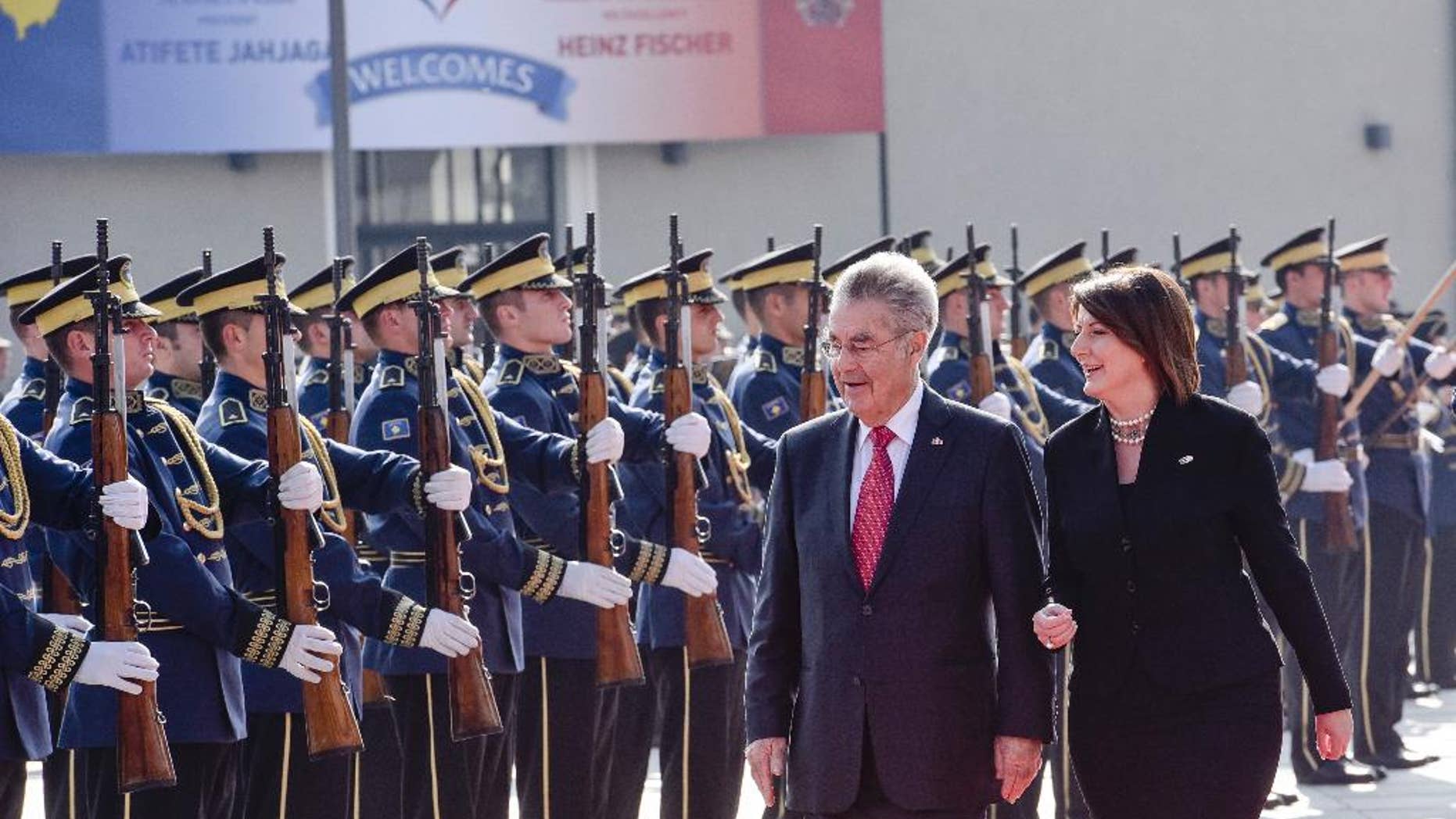 Kosovo President Atifete Jahjaga, right, flanked by Austrian President Heinz Fischer inspecting the honour guard of the Kosovo Security Force, during a welcoming ceremony in Kosovo capital Pristina on Wednesday, Oct. 28, 2015. The Austrian President Heinz Fischer is in a two-day official visit in Kosovo. (AP Photo/Visar Kryeziu)