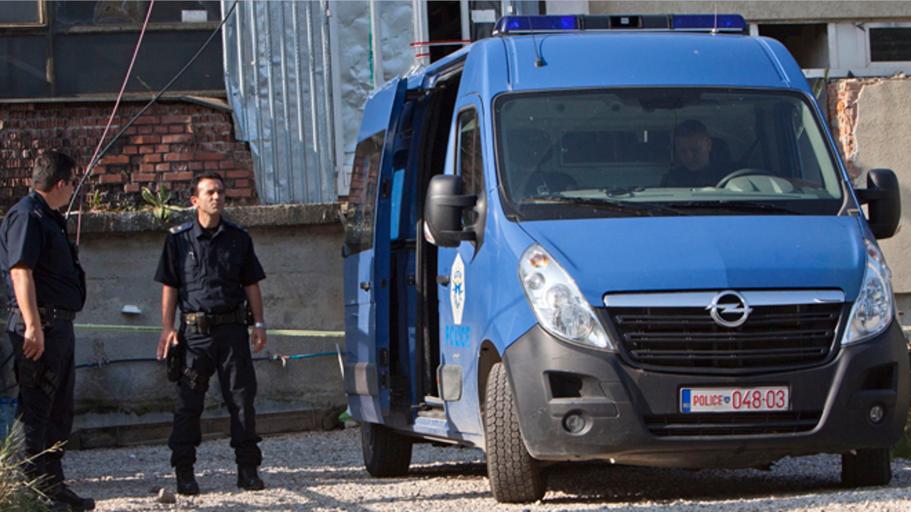 Aug. 11, 2014: Kosovo police officers guard the entrance of a makeshift mosque after a raid in Kosovo's capital Pristina. Kosovo police arrested at least 40 people in a major operation targeting Islamic radicals suspected of fighting alongside extremists in Iraq and Syria.