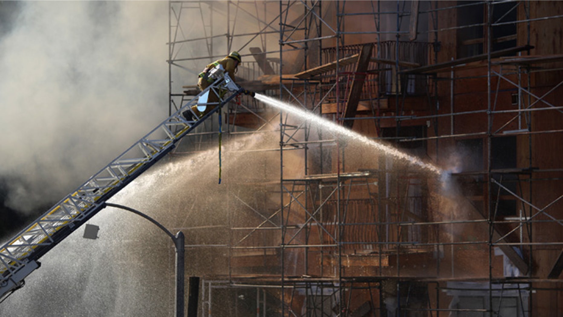 Firefighters battle a fire that destroyed a seven-story apartment building under construction on December 8, 2014 in Los Angeles, California. (Photo by David McNew/Getty Images)