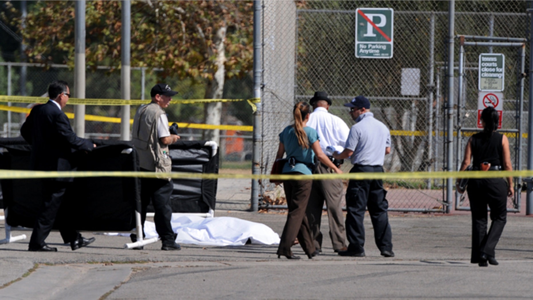 Los Angeles Police Department officers investigate the scene of a shooting Sunday, Aug. 24, 2014, where one person was killed near the 14400 block of Polk Street in Sylmar, Calif. Describing what they called a major public threat, Los Angeles police said they are seeking clues to three separate shootings in the Northeast San Fernando Valley that left three people dead and four others injured early Sunday morning and appear to be connected. A suspect in the shootings was taken into custody by SWAT officers Sunday night after holing up inside a house in the Sylmar neighborhood for about an hour, Capt. William Hayes said. (AP Photo/Los Angeles Daily News, Dean Musgrove)