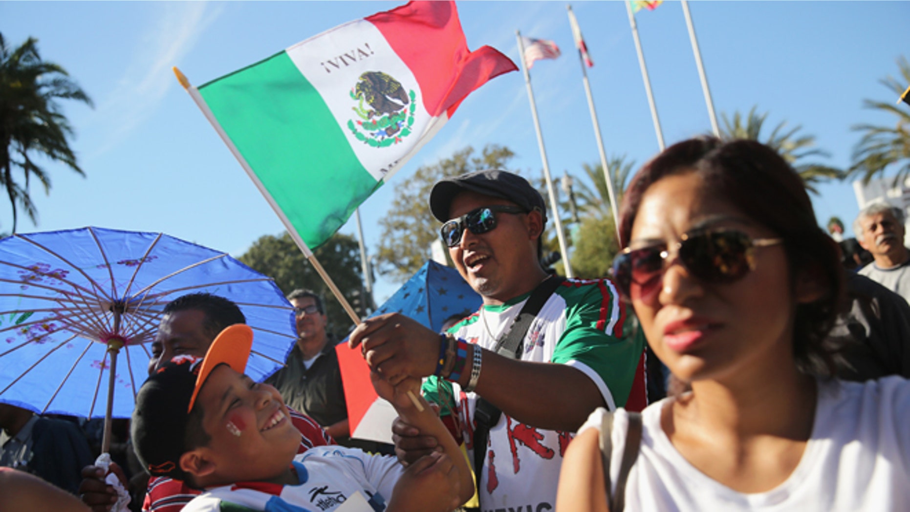 LOS ANGELES, CA - OCTOBER 06: People sing the Mexican national anthem during the opening ceremony of the sixth annual Mole Fair on October 6, 2013 in Los Angeles, California. Thousands of people turned out to taste mole sauce recepies from the Mexican states of Oaxaca and Puebla for what's billed as the largest Mexican food festival in the United States. Los Angeles has the largest Mexican-origin population of any city in the world after Mexico City. (Photo by John Moore/Getty Images)
