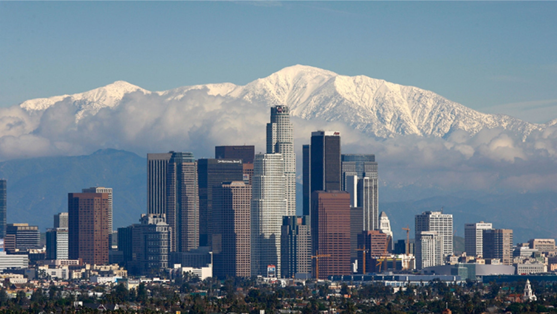 LOS ANGELES, CA - JANUARY 7: Fresh snow blankets the mountains behind the downtown skyline after a series of storms that hammered northern California delivered much needed precipitation to the Greater Los Angeles Area January 7, 2008 in Los Angeles, California. With the threat of mandatory water rationing still in effect because of prolonged drought, the rain is a small step toward relief. Forecasters had predicted flash floods and mudslides near large areas that were denuded by wildfires of historic proportions in October, and some mandatory evacuations were declared, but little damage was reported. (Photo by David McNew/Getty Images)
