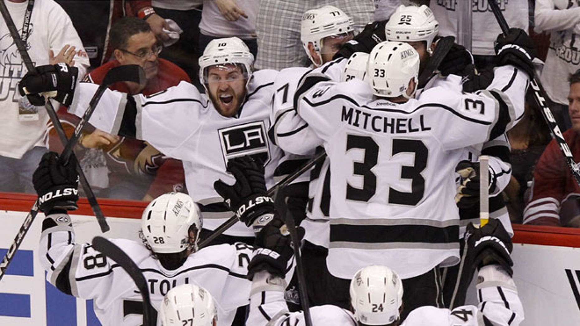 May 22, 2012: Los Angeles Kings' Mike Richards (10) shouts in celebration as teammates Jeff Carter (77), Willie Mitchell (33), Jarret Stoll (28), Alec Martinez (27), and Colin Fraser (24) converge on Dustin Penner (25), who scored the game-winner against the Phoenix Coyotes in overtime during Game 5 of the NHL hockey Stanley Cup Western Conference finals in Glendale, Ariz.