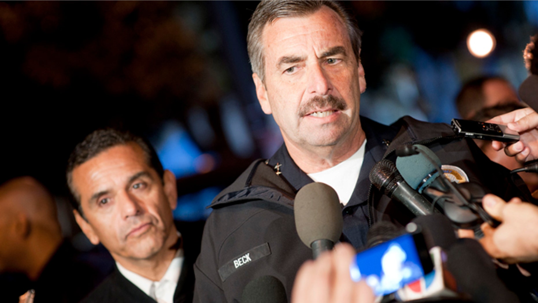 Los Angeles Police Department Chief Charlie Beck talks to members of the media. Behind him is Los Angeles Mayor Antonio Villaraigosa.