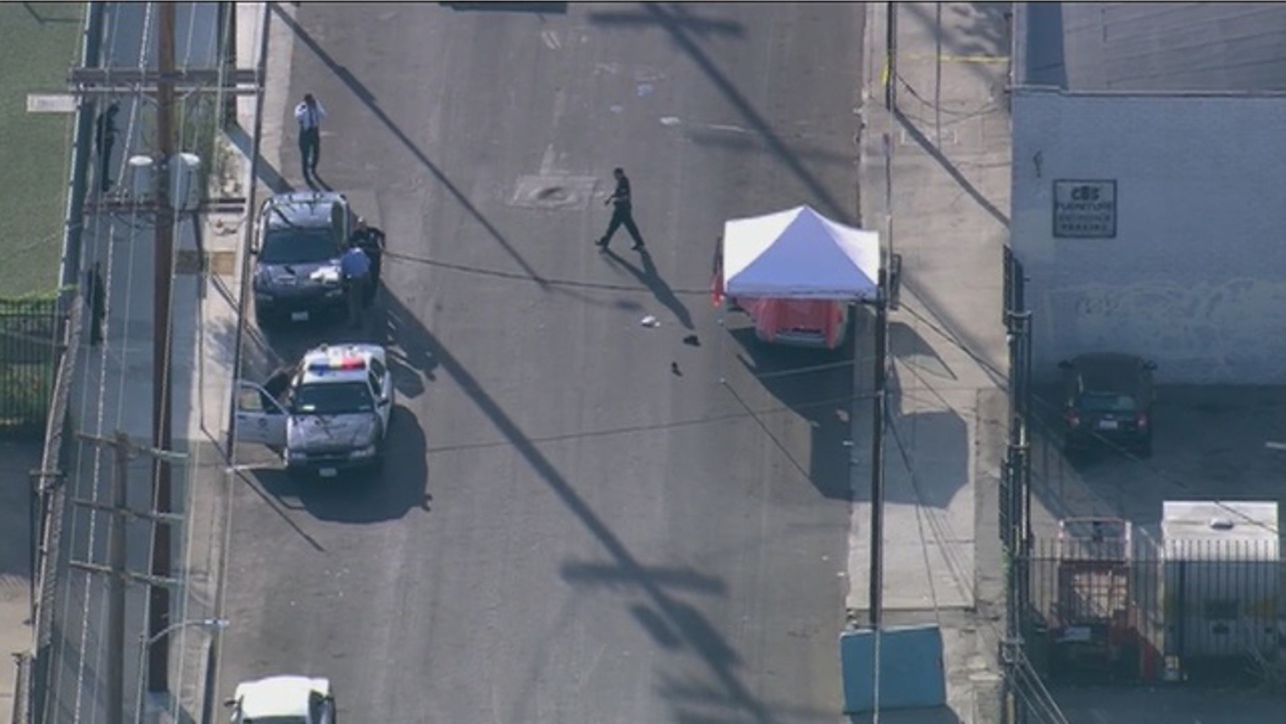 Sept. 9, 2015: Los Angeles police investigate the scene of a triple homicide in which three boys between the ages of 8 and 12 were stabbed to death. (KTTV)