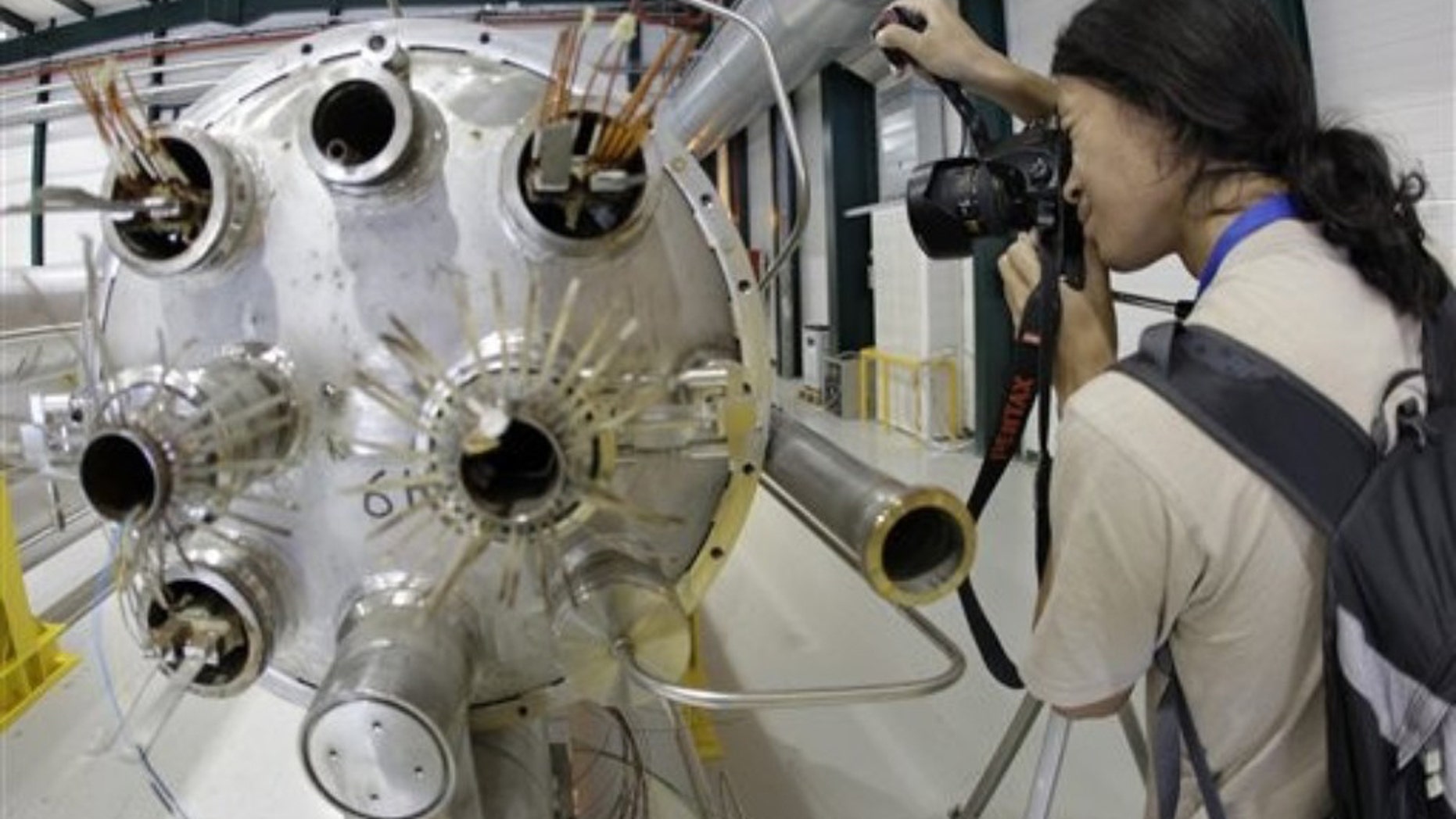 Aug. 7, 2010: An amateur photographer takes a picture in the assembly room of the elements of the LHC (large hadron collider) during the Particle Physics Photowalk at the European Particle Physics laboratory (CERN) in Geneva, Switzerland.