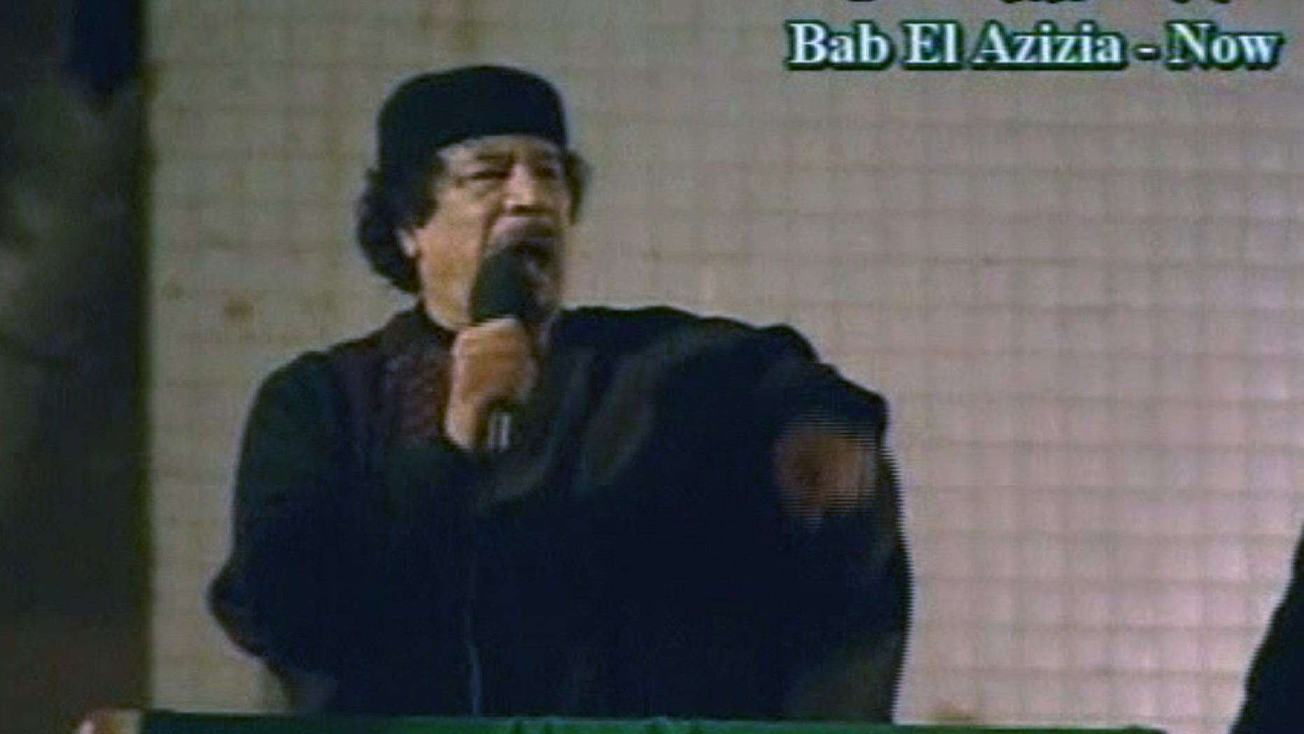 he talks to a large crowd in Bab El Azizia, Libya.