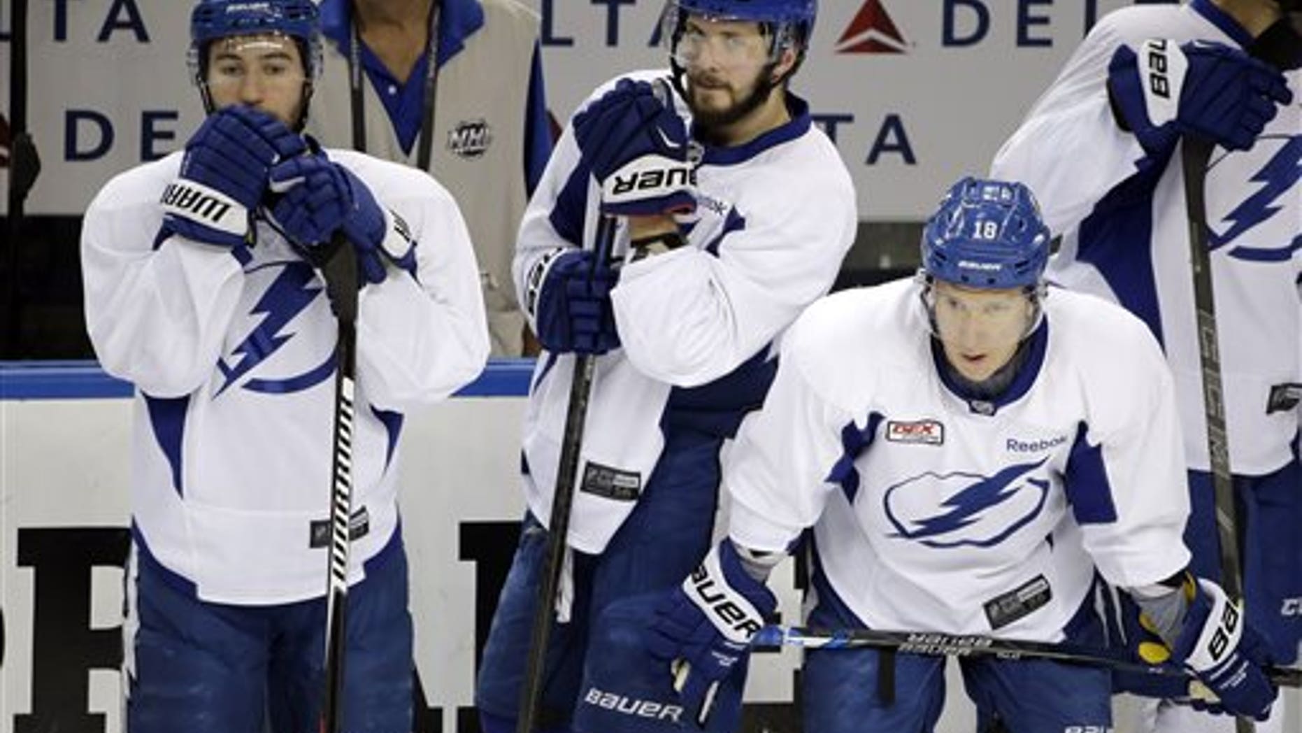 Tampa Bay Lightning players, from left, Tyler Johnson, Nikita Kucherov, and Ondrej Palat, also known as the triplets, watch drills during NHL hockey practice at Amalie Arena for the Stanley Cup Finals, Tuesday, June 2, 2015, in Tampa, Fla. (AP Photo/Chris O'Meara)