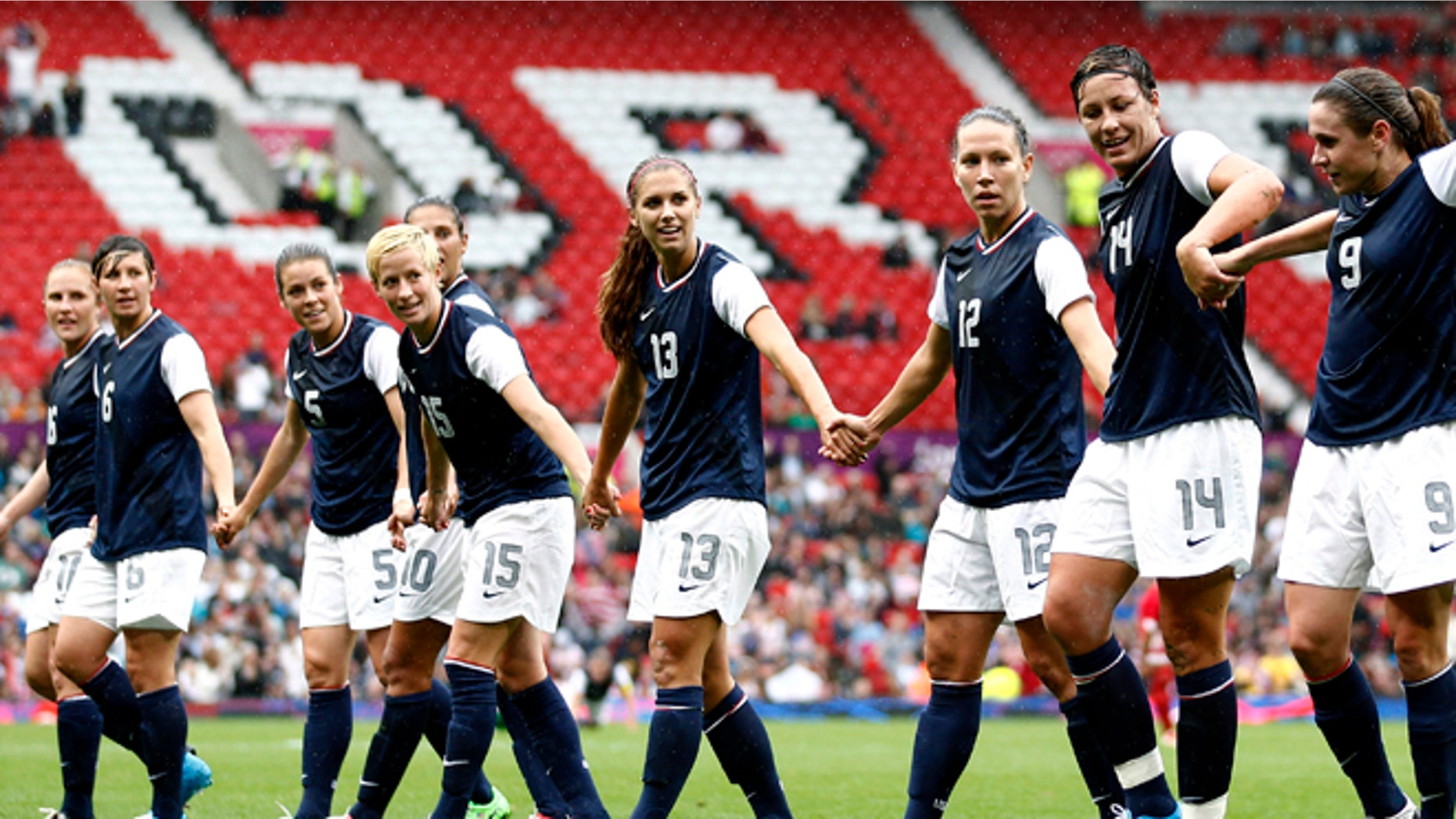 July 31, 2012: United States' Abby Wambach (14) celebrates with teammates after scoring against North Korea during their group G women's soccer match at the London 2012 Summer Olympics, at Old Trafford Stadium in Manchester, England.