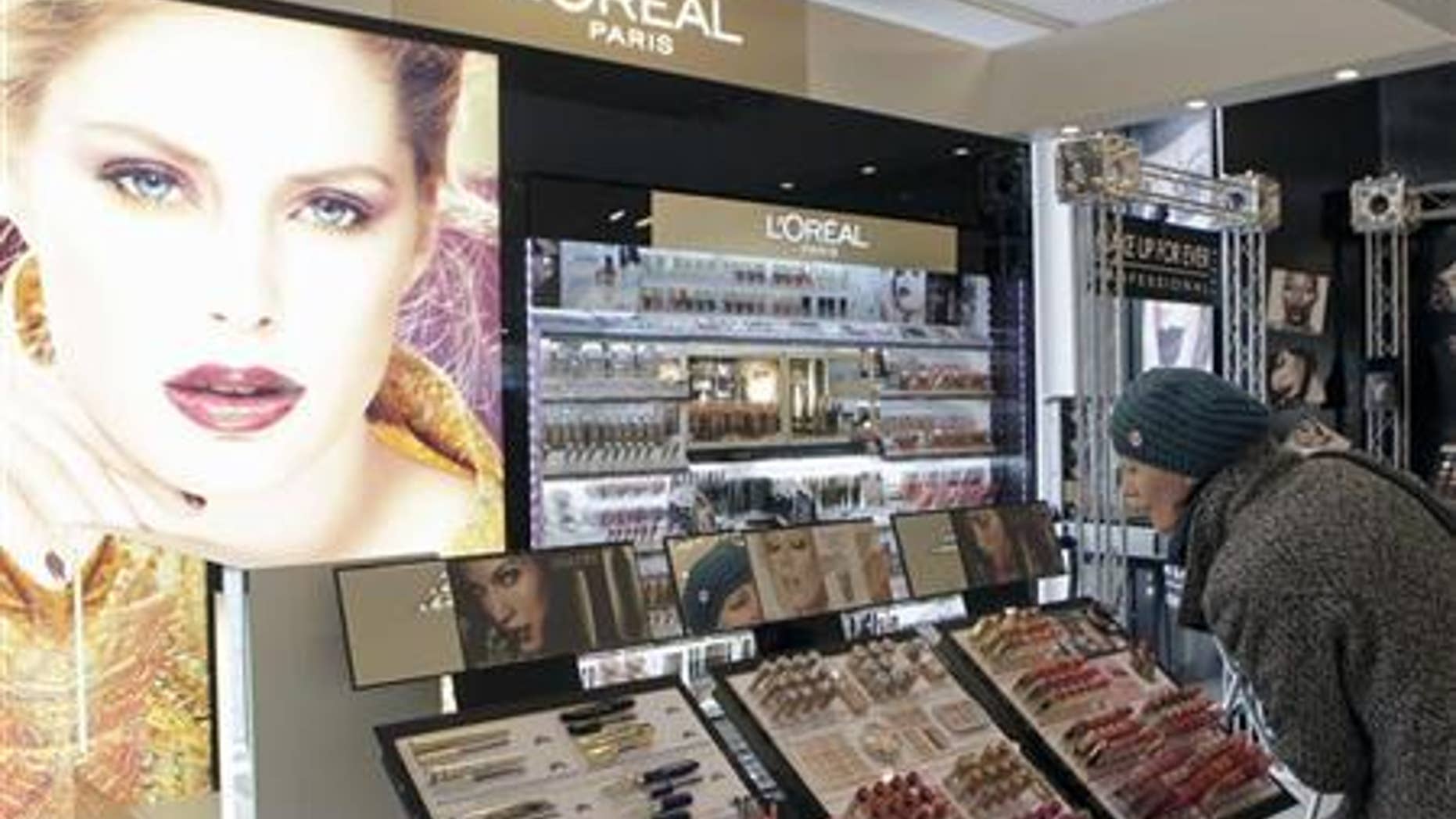 A woman looks at L'Oreal cosmetics in the shop in Riga April 13, 2012. REUTERS/Ints Kalnins