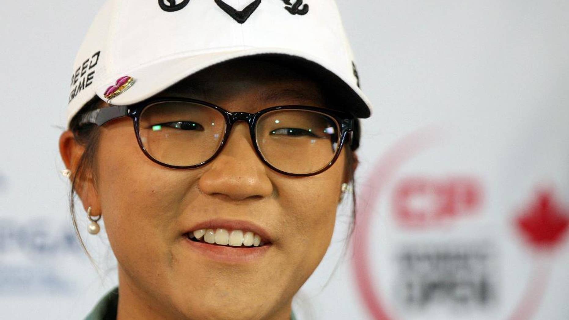 FILE - This is an Aug. 20, 2014, file photo showing Lydia Ko answering questions at the Canadian Pacific Women's Open golf tournament in London, Ontario. Ko has become the youngest player to win the LPGA Tour's rookie of the year award. The 17-year-old Ko clinched the points-based award with three tournaments remaining on the LPGA Tour schedule. (AP Photo/The Canadian Press, Dave Chidley, File)