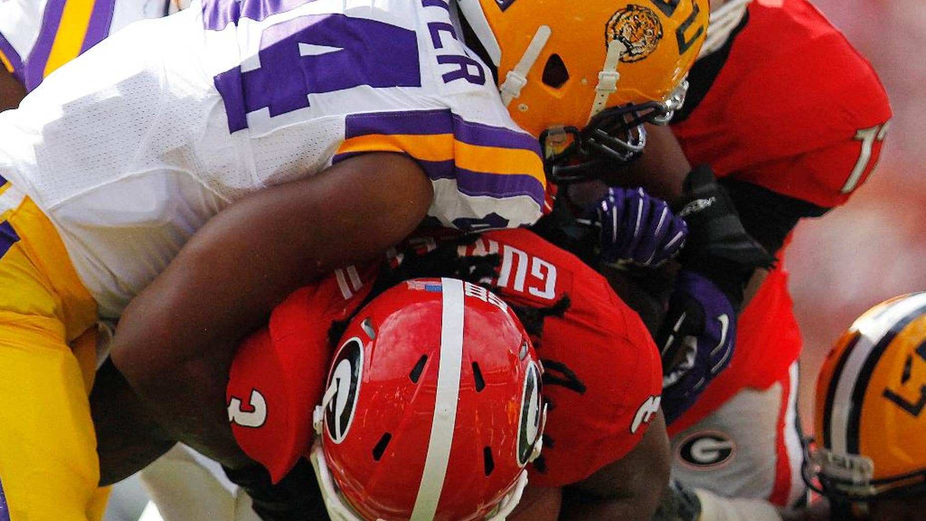 FILE - In this Sept. 28, 2013, file photo, Georgia running back Todd Gurley (3) is hit by LSU defensive end Danielle Hunter (94) during the first half of an NCAA college football game in Athens, Ga. When Hunter decided this summer that he would start trusting his instincts and stop overthinking things, he got off the snap quicker and began making life exceedingly difficult for Tigers offensive linemen in practice. (AP Photo/Mike Stewart, File)