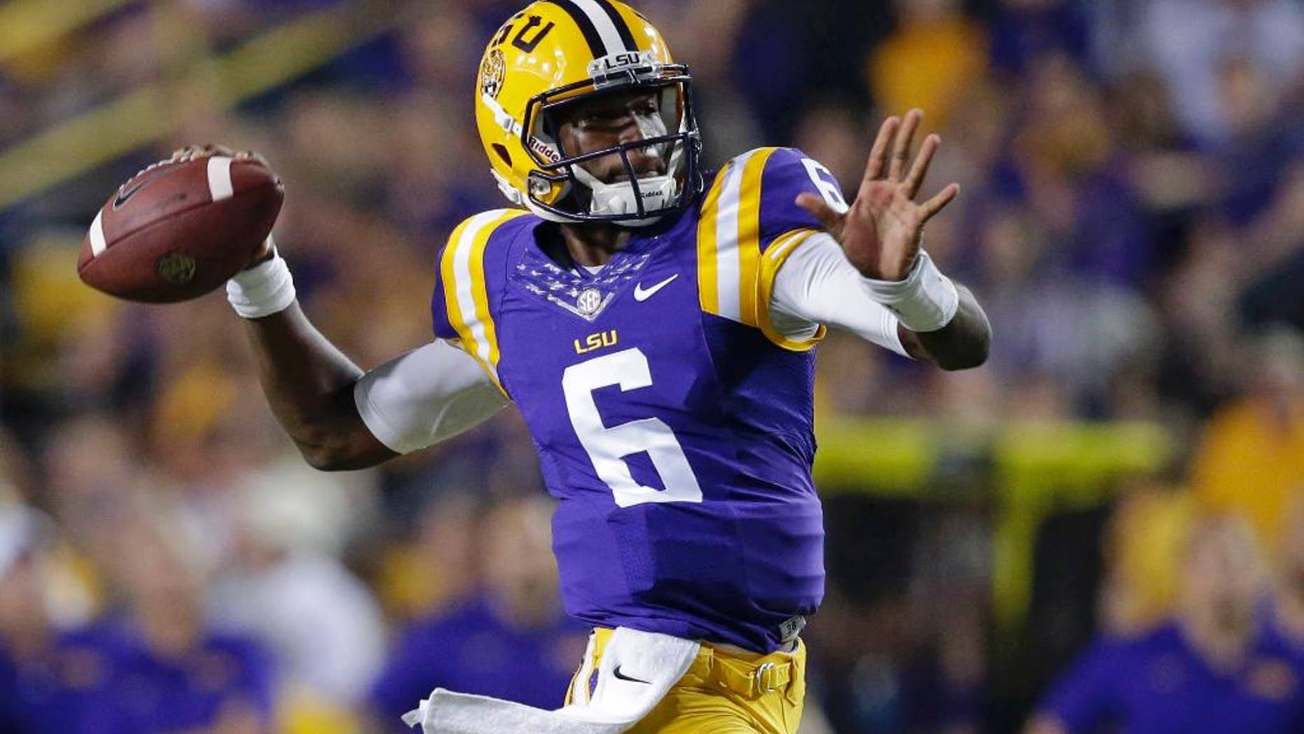 FILE - In this Saturday, Sept. 27, 2014, file photo, LSU quarterback Brandon Harris (6) throws a touchdown pass to wide receiver Malachi Dupre, not pictured, during the first half of an NCAA college football game against New Mexico State in Baton Rouge, La. LSU coach Les Miles announced Monday, Sept. 29, 2014, that true freshman will start at quarterback against Auburn on Saturday. (AP Photo/Gerald Herbert, File)