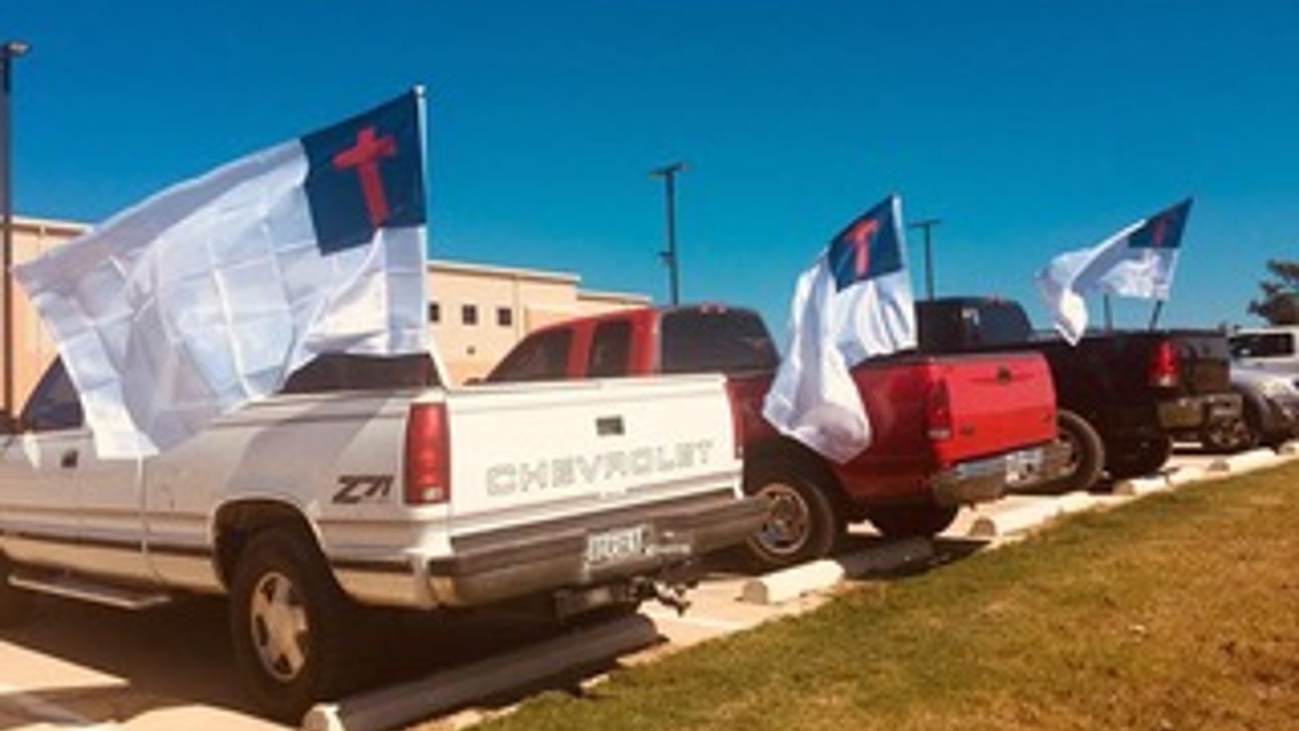 Students' trucks flying the Christian flag at LaPoynor High School in LaRue, Texas.