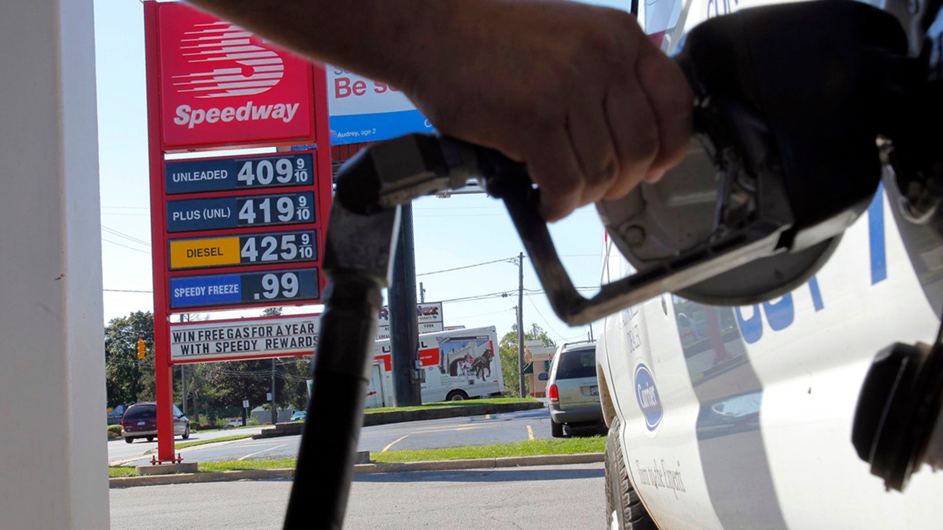 FILE-In this Tuesday, Aug. 28, 2012, file photo, a man pumps gas into his van while a sign advertises that a gallon of regular unleaded costs $4.09 at the Speedway on South Westnedge Avenue in Kalamazoo, Mich. Drivers are facing the biggest one-day jump in gasoline prices in 18 months, Wednesday, Aug. 29, 2012, as Hurricane Isaac swamps the nation's oil and gas hub along the Gulf Coast. The nationwide average for a gallon of regular gas rose a nickel Wednesday to $3.80 as refineries shut down or cut back to protect against Isaac's high winds and heavy rain. (AP Photo/Kalamazoo Gazette, Mark Bugnaski)