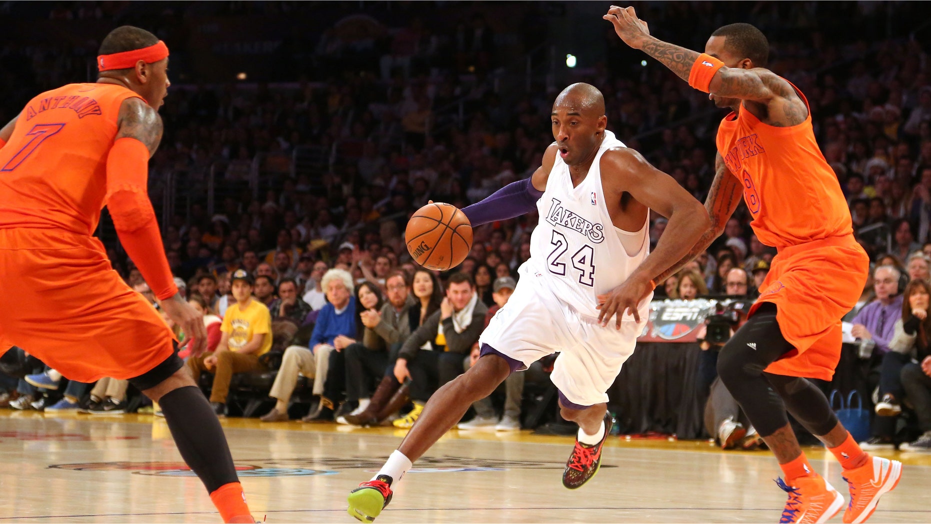 Kobe Bryant #24 of the Los Angeles Lakers dribbles to the basket against J.R. Smith #8 and Carmelo Anthony #7 of the New York Knicks in the first half during the NBA game at Staples Center on December 25, 2012 in Los Angeles, California.(Photo by Victor Decolongon/Getty Images)
