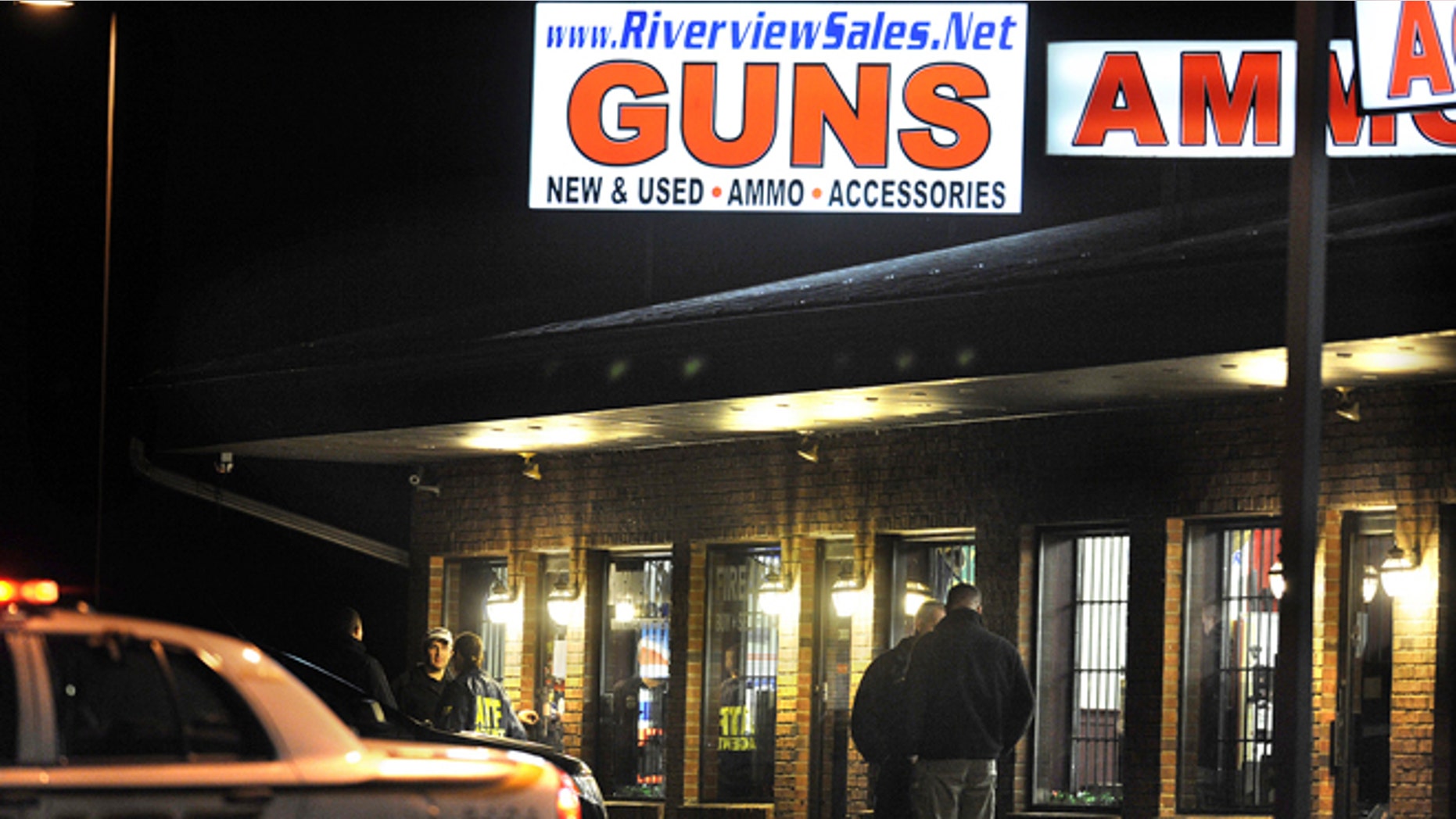 Dec. 20, 2012: In this photo, law enforcement officials stand outside Riverview Gun Sales, as authorities raid the store in East Windsor, Conn.