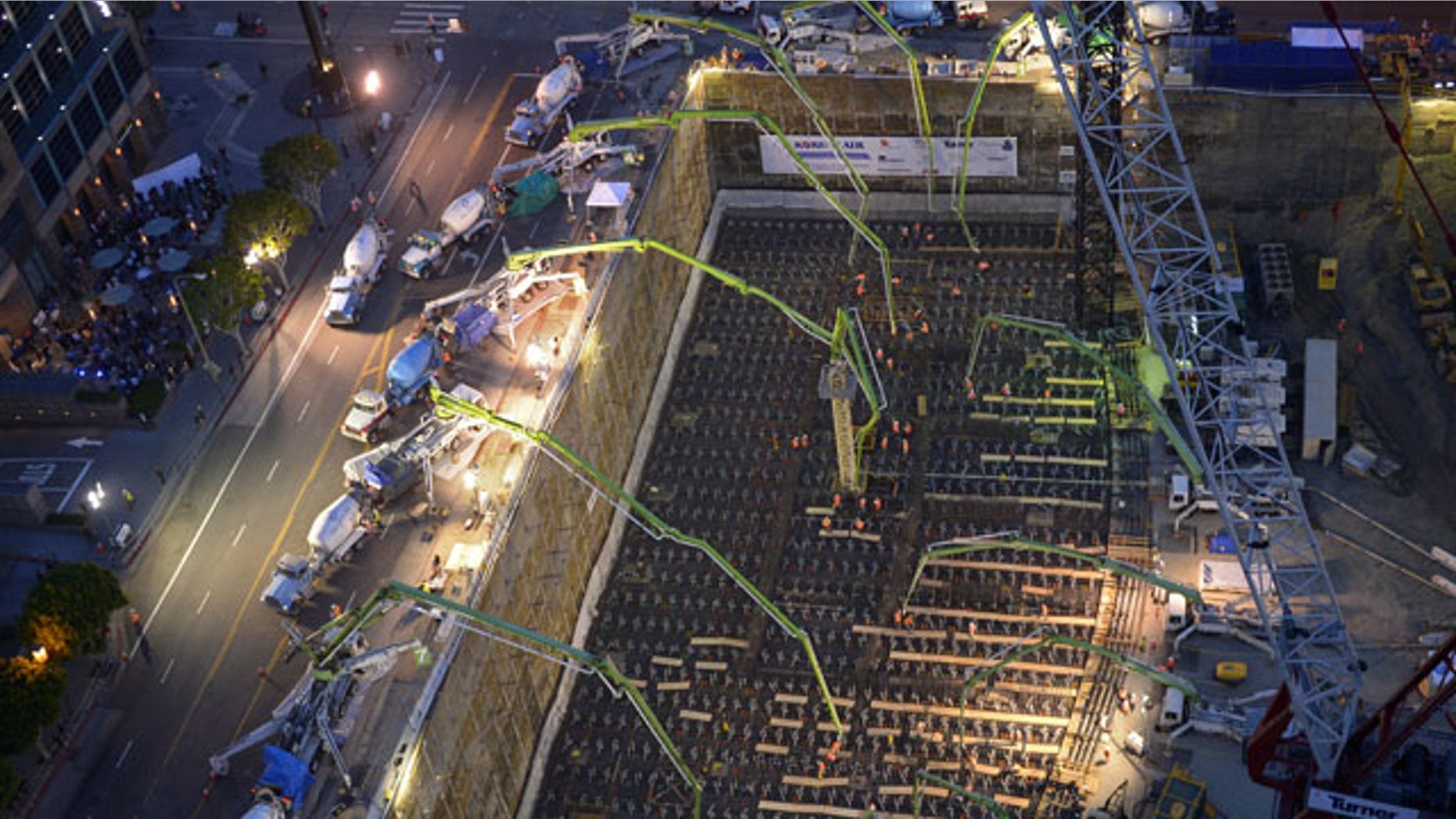 February 15, 2014: Crews pour concrete to lay the foundation for the New Wilshire Grand building in a record attempt for the largest continuous concrete pour in history in downtown Los Angeles. The marathon pour is expected to last 20 hours without interruption. (AP Photo/Mark J. Terrill)