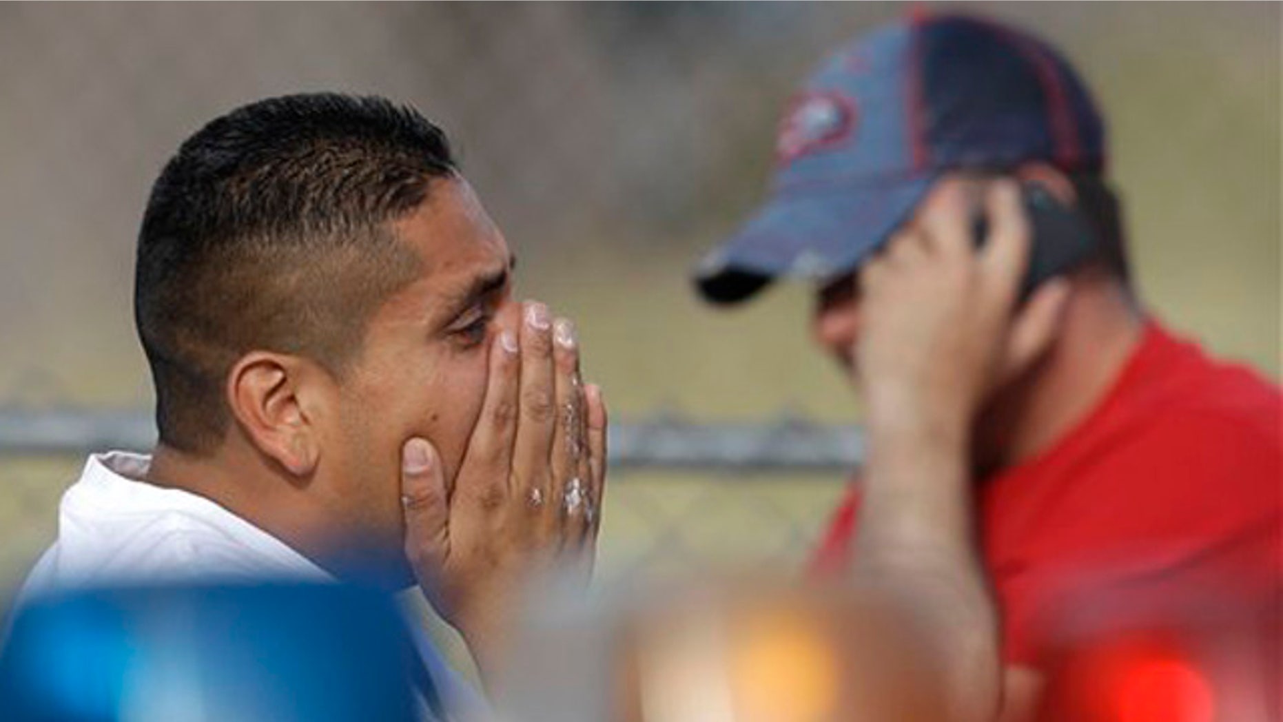 April 16, 2012: The brother of a murder victim reacts at a police road block near the home site where her body was found with her daughter's in Las Vegas.