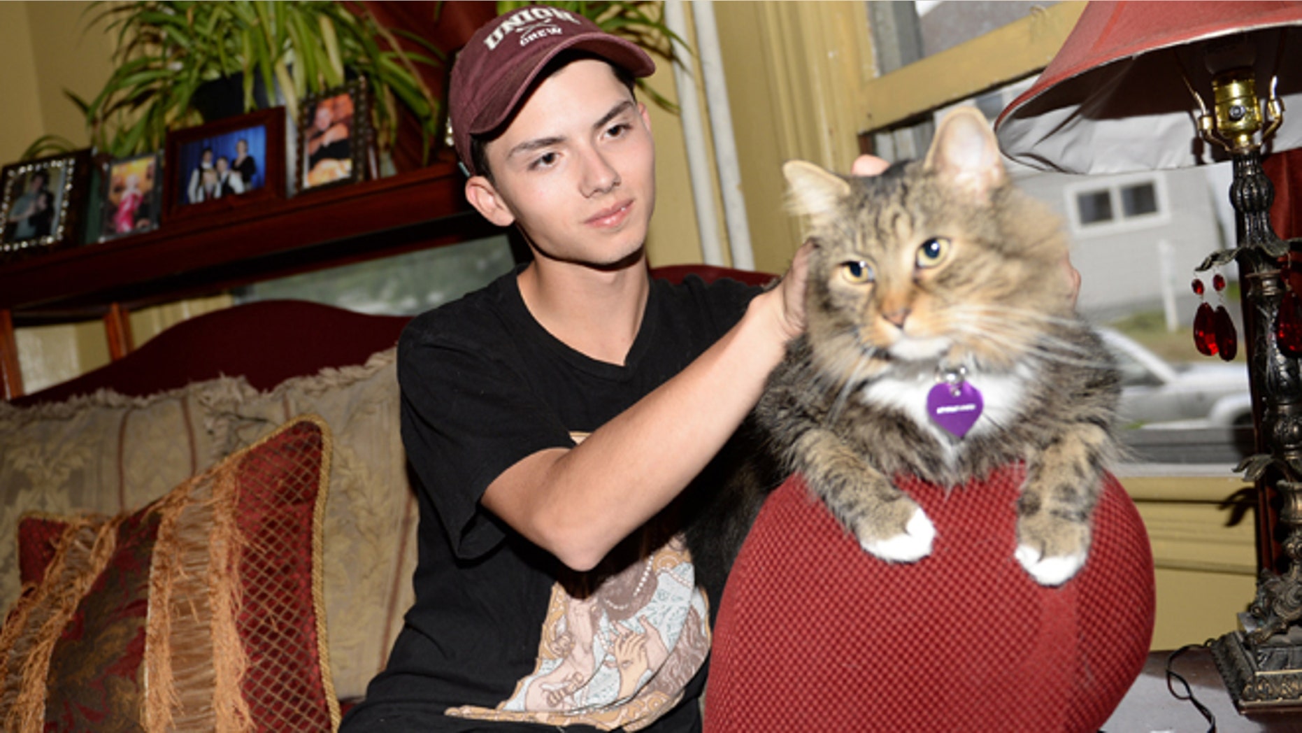 Sept. 10, 2014: In a file photo, Draven Rodriguez and his cat Mr. Bigglesworth at their home in Schenectady, N.Y. (AP/The Daily Gazette, Patrick Dodson)