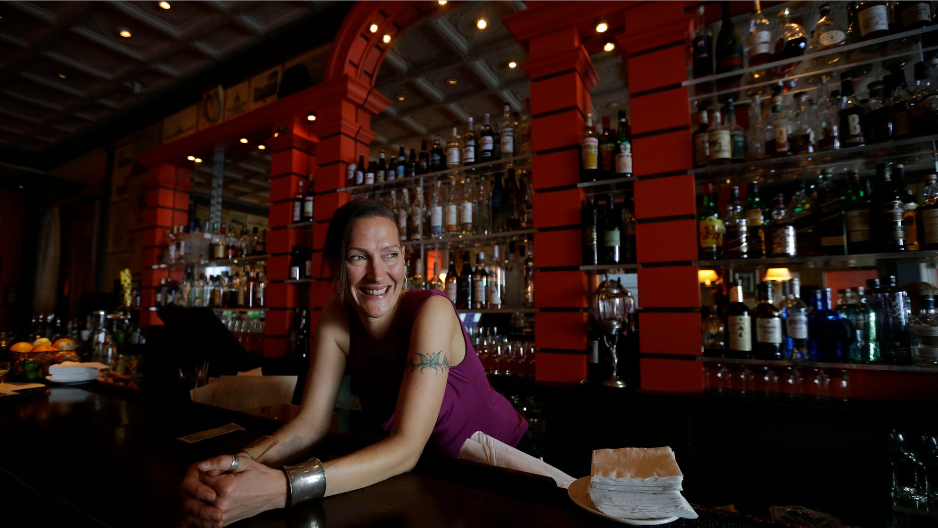 Bartender Valen West smiles while speaking to reporter at Zare at Fly Trap in San Francisco, Wednesday, April 3, 2013. Across California, 2 a.m. is the witching hour for bartenders to issue the last call for drinks. But a proposed state law would give nightlife loving cities the option of allowing their bars and clubs to keep serving drinks for two more hours. (AP Photo/Jeff Chiu)