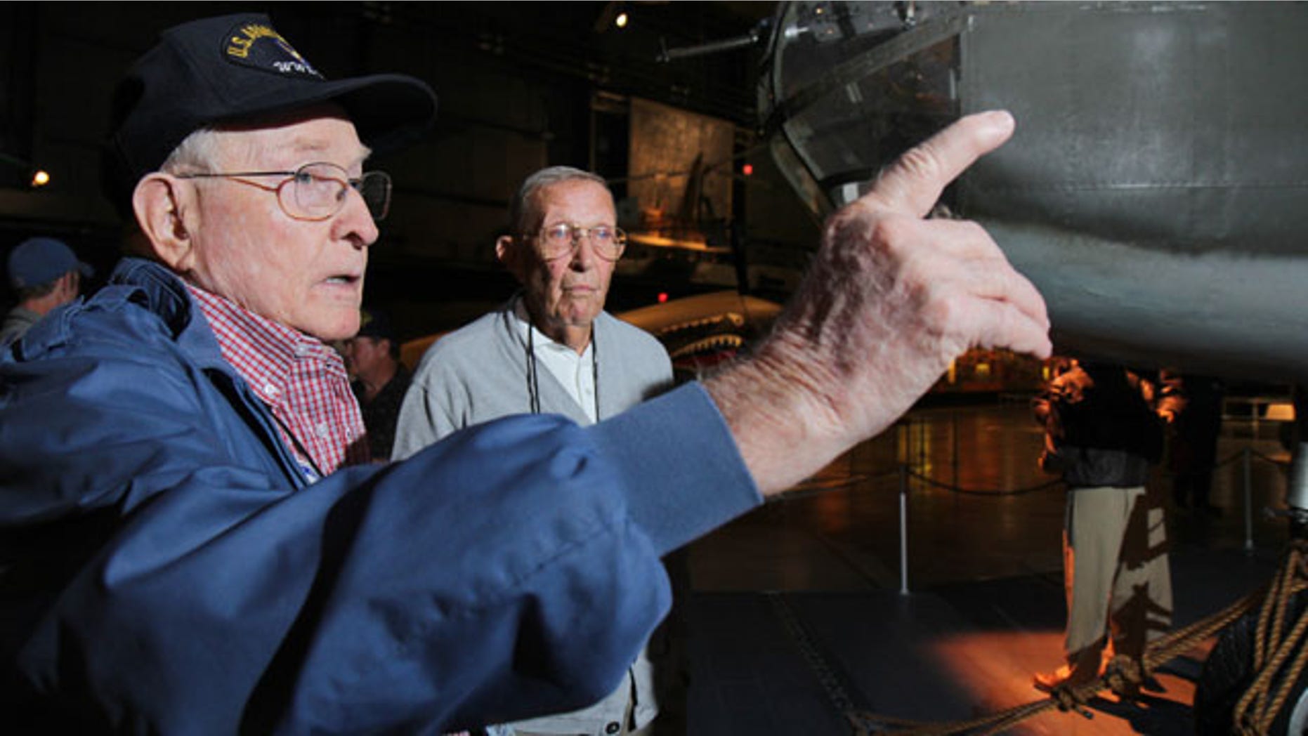 September 27, 2013: Former B-25 crewman Robert Crouse and former pilot Paul Young talk about their World War II experiences during a reunion of the 57th Bomb Wing in front of a B-25 bomber in the U.S. Air Force Museum at Wright Patterson Air Force base in Dayton, Ohio. (AP Photo)