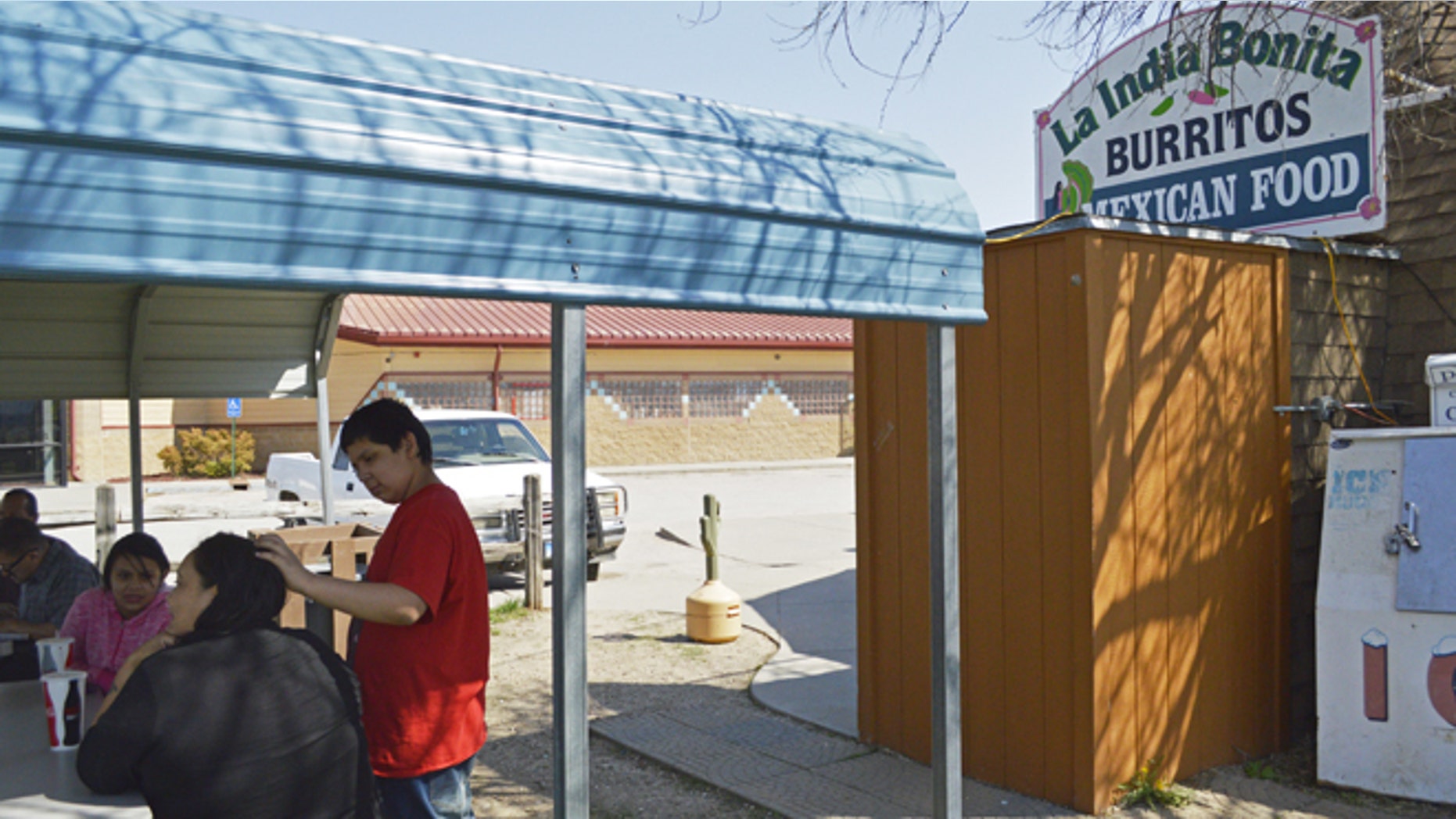 FILE - In this May 1, 2015 file photo, customers eat outside La India Bonita Mexican Restaurant in Kyle, S.D., on the Pine Ridge Indian Reservation. The population growth of U.S. Latinos is slowing thanks to lower immigration and declining birthrates, although states like North Dakota, South Dakota, and Tennessee are seeing Latino population spikes, according to a Pew Research Center study released Thursday, Sept. 8, 2016. (AP Photo/Russell Contreras, File)