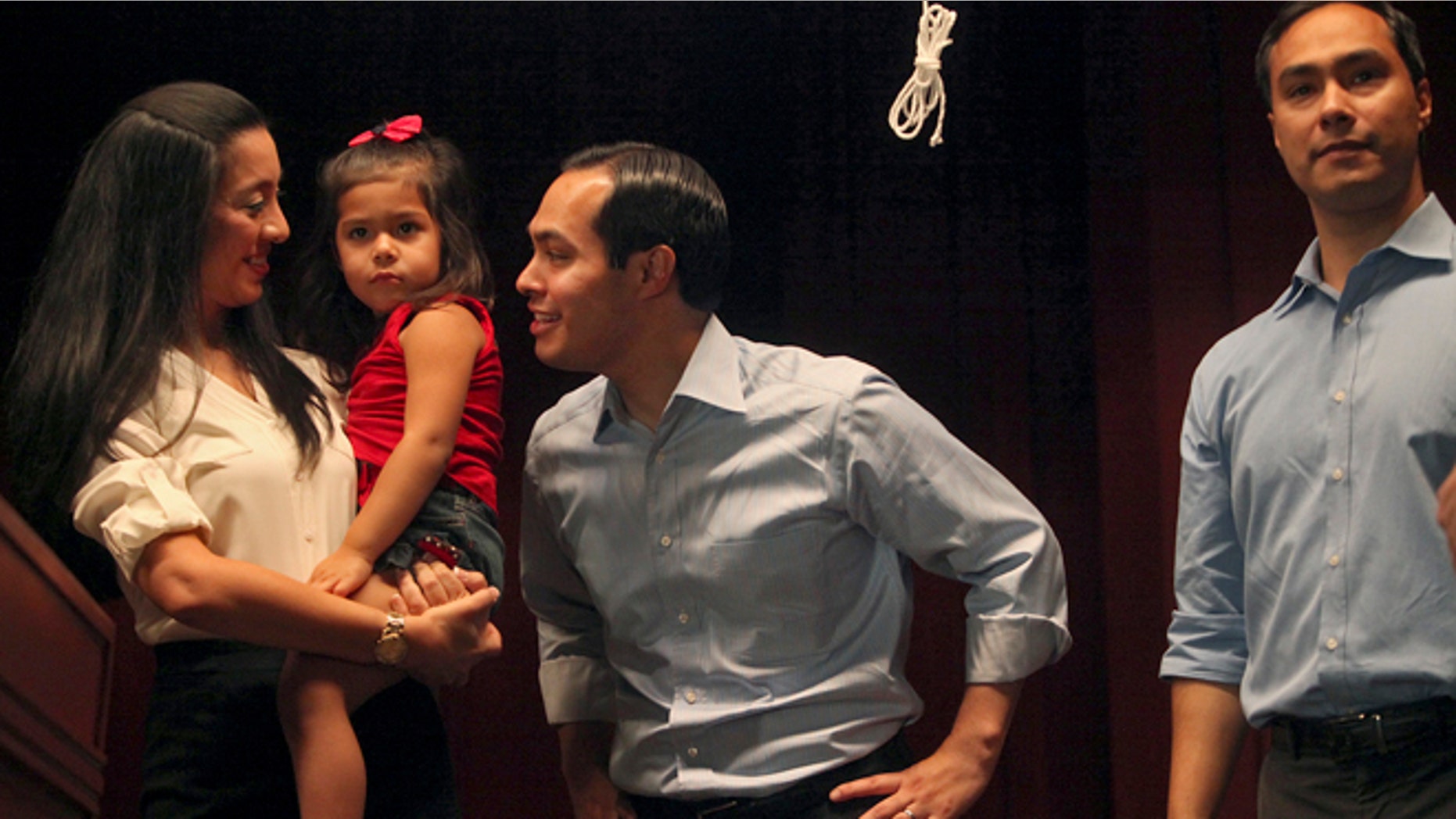 Mayor Julian Castro, center, stands with his wife, Erica Castro, their daughter, Carina, 3, and his brother, Joaquin Castro, right, on stage during the send-off party for their trip to the Democratic National Convention at the St. Paul Community Center in San Antonio on Sept. 1, 2012. Castro delivers the convention's keynote address Tuesday, a nod to the importance of Hispanic voters in the race. (AP Photo/San Antonio Express-News, Lisa Krantz)