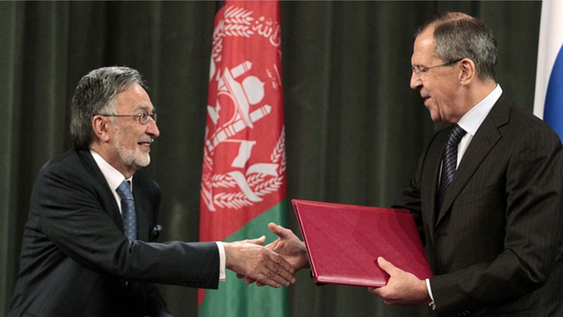 Nov. 25: Russia's Foreign Minister Sergei Lavrov, right, shakes hands with his Afghan counterpart Zalmay Rasul during a signing ceremony in Moscow, where Lavrov said Russia will allow NATO to take armored vehicles to Afghanistan through its territory under an expanded transit deal.