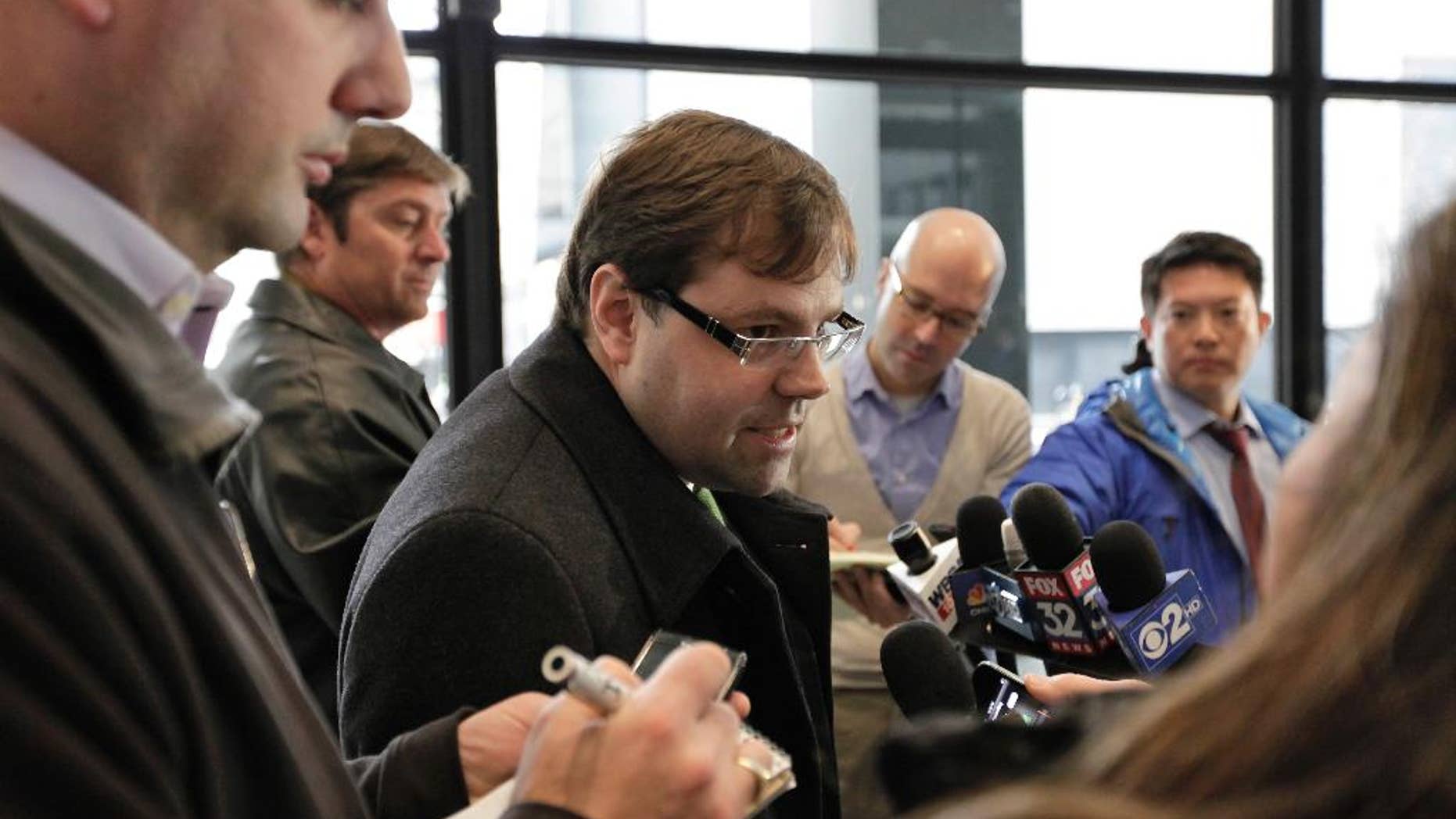 FILE - In this Dec. 21, 2012 file photo, attorney Beau Brindley, center, speaks with reporters at the federal courthouse in Chicago. Closing arguments were planned for Thursday, Aug. 27, in the federal bench trial of Brindley, who is facing obstruction-of-justice charges. (AP Photo/Teresa Crawford, File)