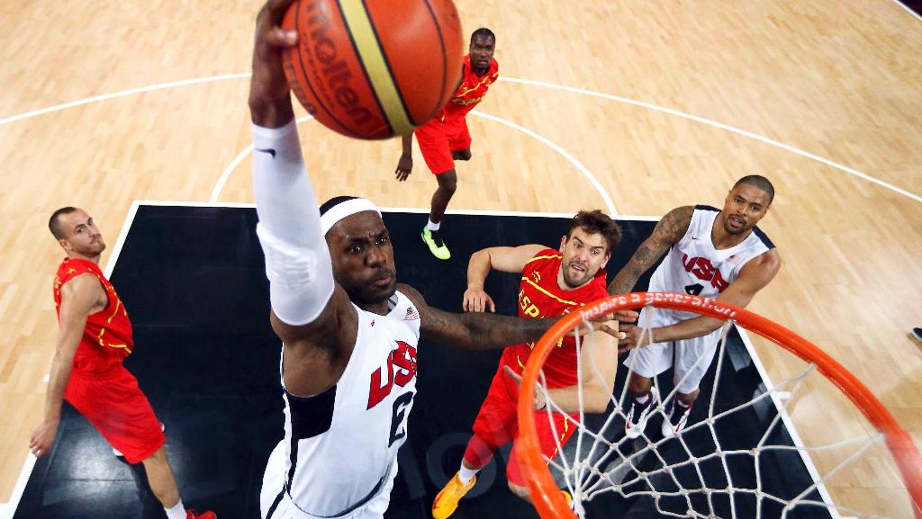 FILE - In this Aug. 12, 2012, file photo, United States' LeBron James (6) dunks against Spain during the men's gold medal basketball game at the 2012 Summer Olympics in London. James said Monday, Sept. 29, 2014, following the Cavaliers' practice that he's "nowhere near" deciding if he'll again play for Team USA in two years for the 2016 Olympics. (AP Photo/Christian Petersen, Pool, File)
