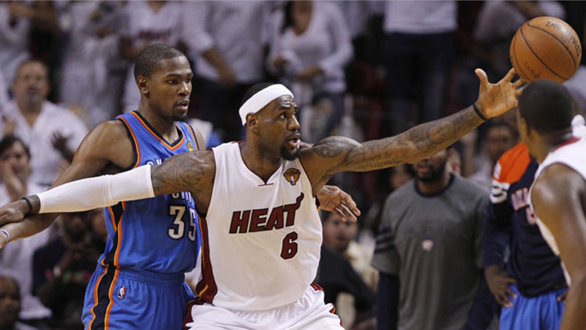 June 19, 2012: Miami Heat small forward LeBron James (6) reels in the ball as Oklahoma City Thunder small forward Kevin Durant (35) defends during the second half at Game 4 of the NBA Finals basketball series in Miami.