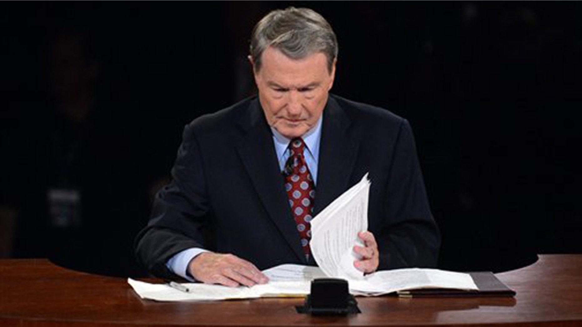 Oct. 3, 2012: Moderator Jim Lehrer looks over his notes before the first presidential debate at the University of Denver, in Denver.